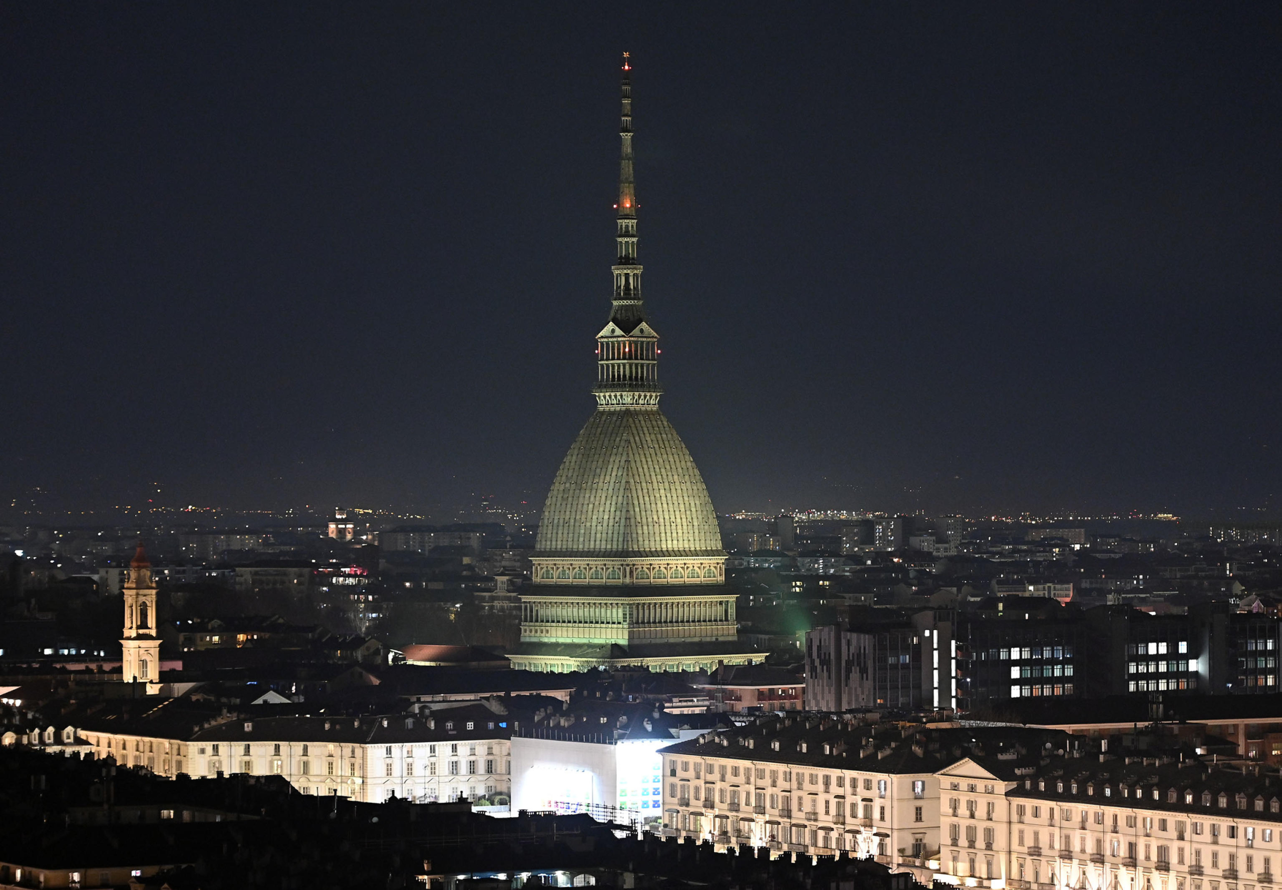 A view of the Mole Antonelliana with switched off illumination to mark Earth Hour, in Turin, Italy, 26 March 2022. Landmark buildings turn off their lights for one hour to take part in the Earth Hour movement as a sign of their commitment to the planet. Earth Hour is an annual event organized by the WWF World Wide Fund for Nature in which lights are switched off in major cities around the world to draw attention to energy consumption and its environmental effects. ANSA/ ALESSANDRO DI MARCO