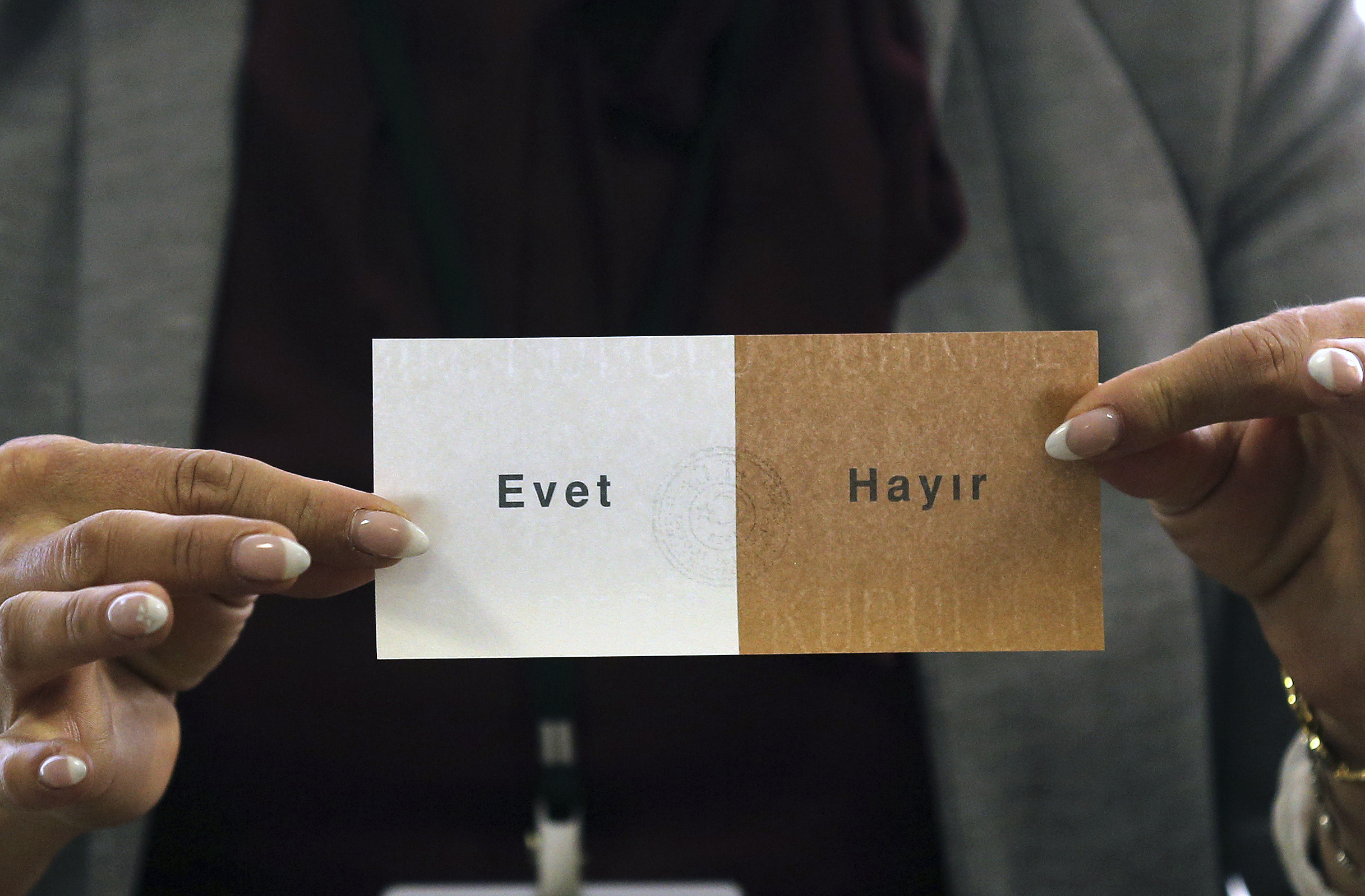 A Turkish female showing a ballot with the Turkish words for 'Yes' and 'No'('Evet' and 'Hayir') in a Turkish electoral polling station in Dortmund, Germany, 09 April 2017. The Turkish people of Germany are also called upon to vote on the controversial constitution plans of Turkish President Erdogan. The constitutional reform would give the head of state much more power in Turkey. Photo by: Ina Fassbender/picture-alliance/dpa/AP Images