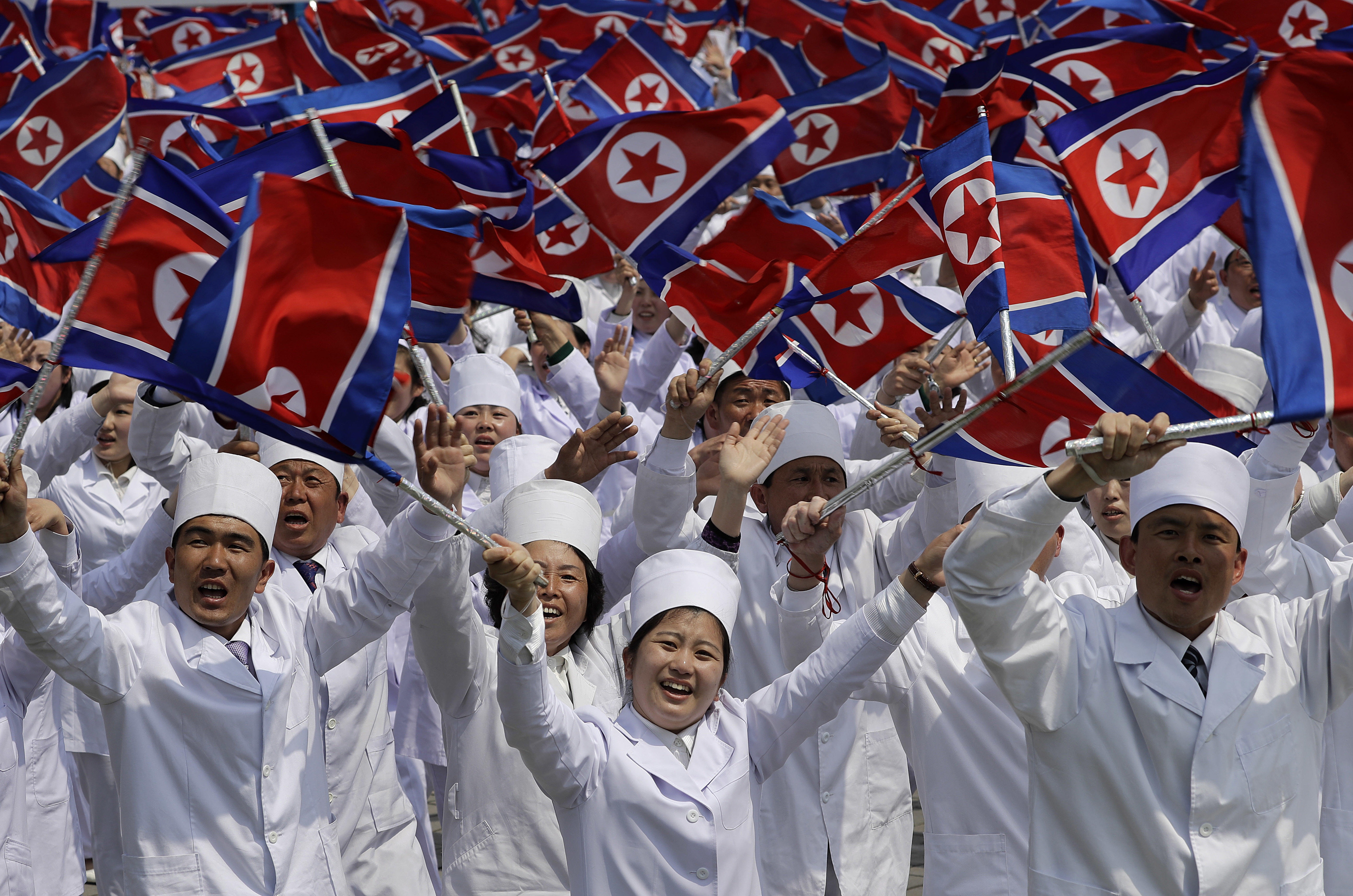 North Korean men and women dressed to represent doctors and other medical workers march across Kim Il Sung Square during a military parade on Saturday, April 15, 2017, in Pyongyang, North Korea to celebrate the 105th birth anniversary of Kim Il Sung, the country's late founder and grandfather of current ruler Kim Jong Un. (AP Photo/Wong Maye-E)