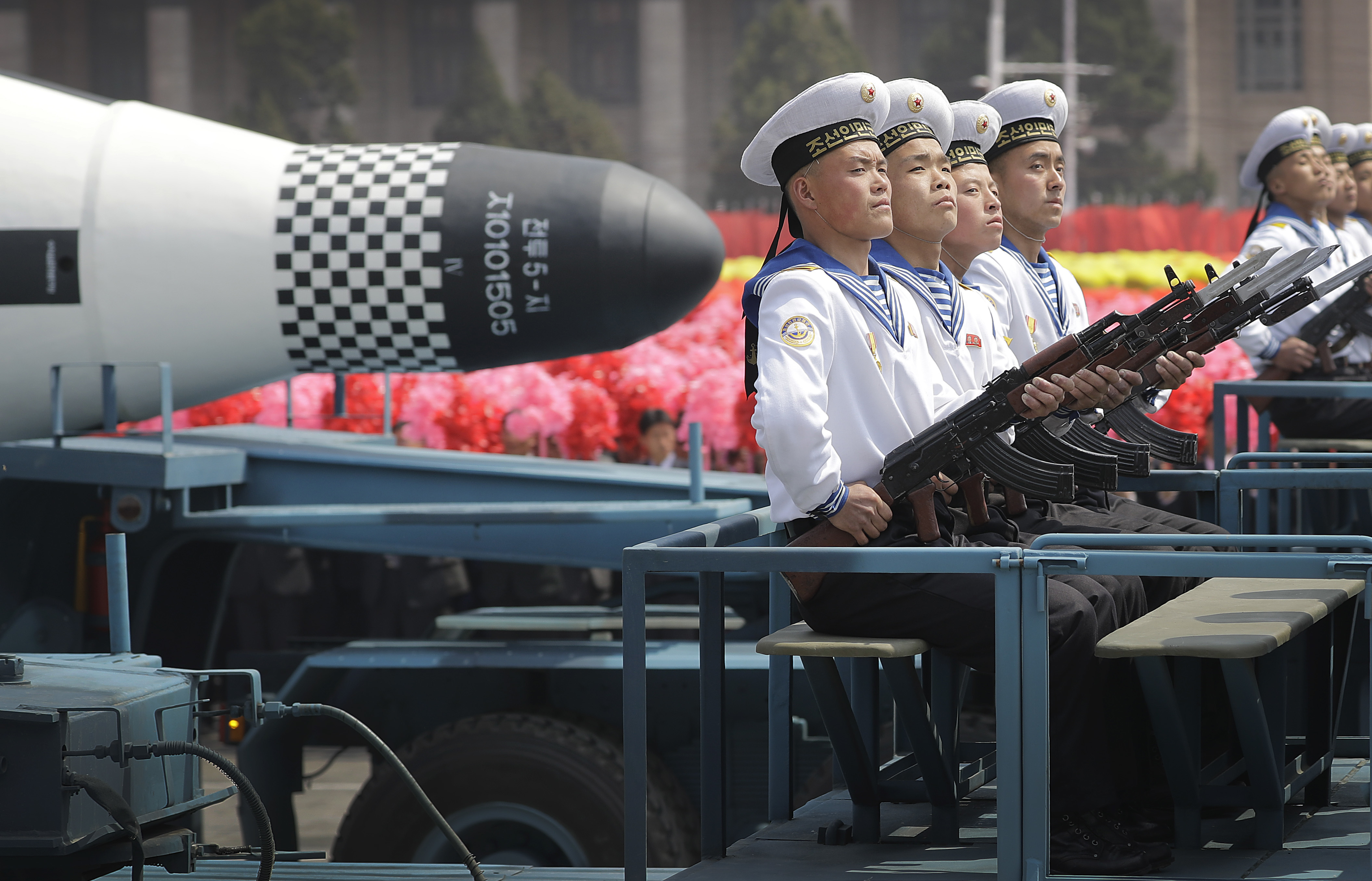 Navy personnel sit in front of a submarine-launched ballistic missile (SLBM) during a military parade on Saturday, April 15, 2017, in Pyongyang, North Korea to celebrate the 105th birth anniversary of Kim Il Sung, the country's late founder and grandfather of current ruler Kim Jong Un. (AP Photo/Wong Maye-E)