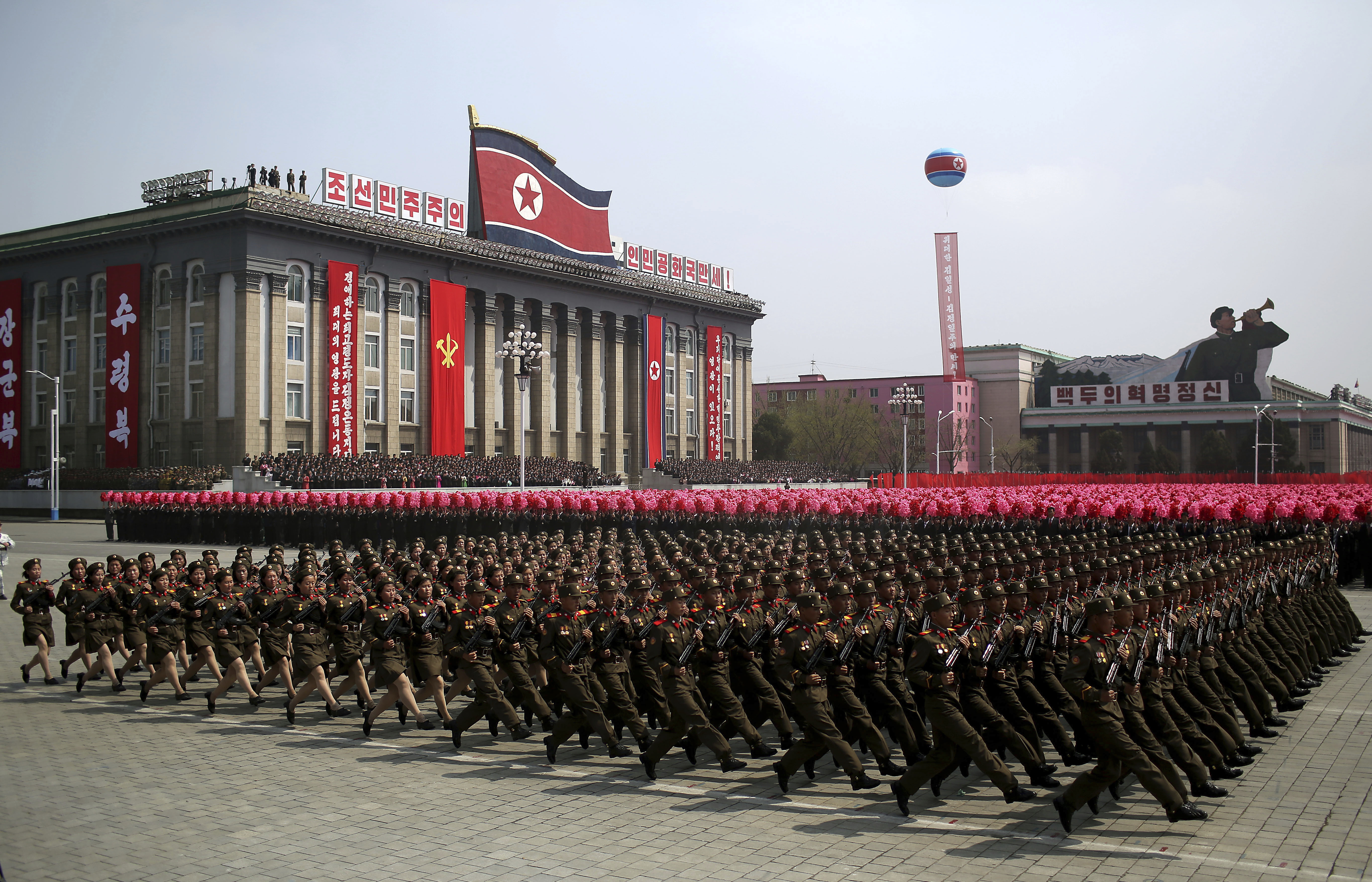 In this Saturday, April 15, 2017, file photo, a soldiers march across Kim Il Sung Square during a military parade in Pyongyang, North Korea to celebrate the 105th birth anniversary of Kim Il Sung, the country's late founder and grandfather of current ruler Kim Jong Un. North Korea's big day, the anniversary of the birth of its founding leader, Kim Il Sung, came and went with no underground nuclear test by the North, and no pre-emptive strikes off the deck of the USS Carl Vinson aircraft carrier sent to waters off the Korean Peninsula by President Donald Trump. Just hours before Vice President Mike Pence began his visit to Seoul on Sunday, Pyongyang fired off a ballistic missile — but it appears to have exploded seconds after it got off the ground. (AP Photo/Wong Maye-E, File)