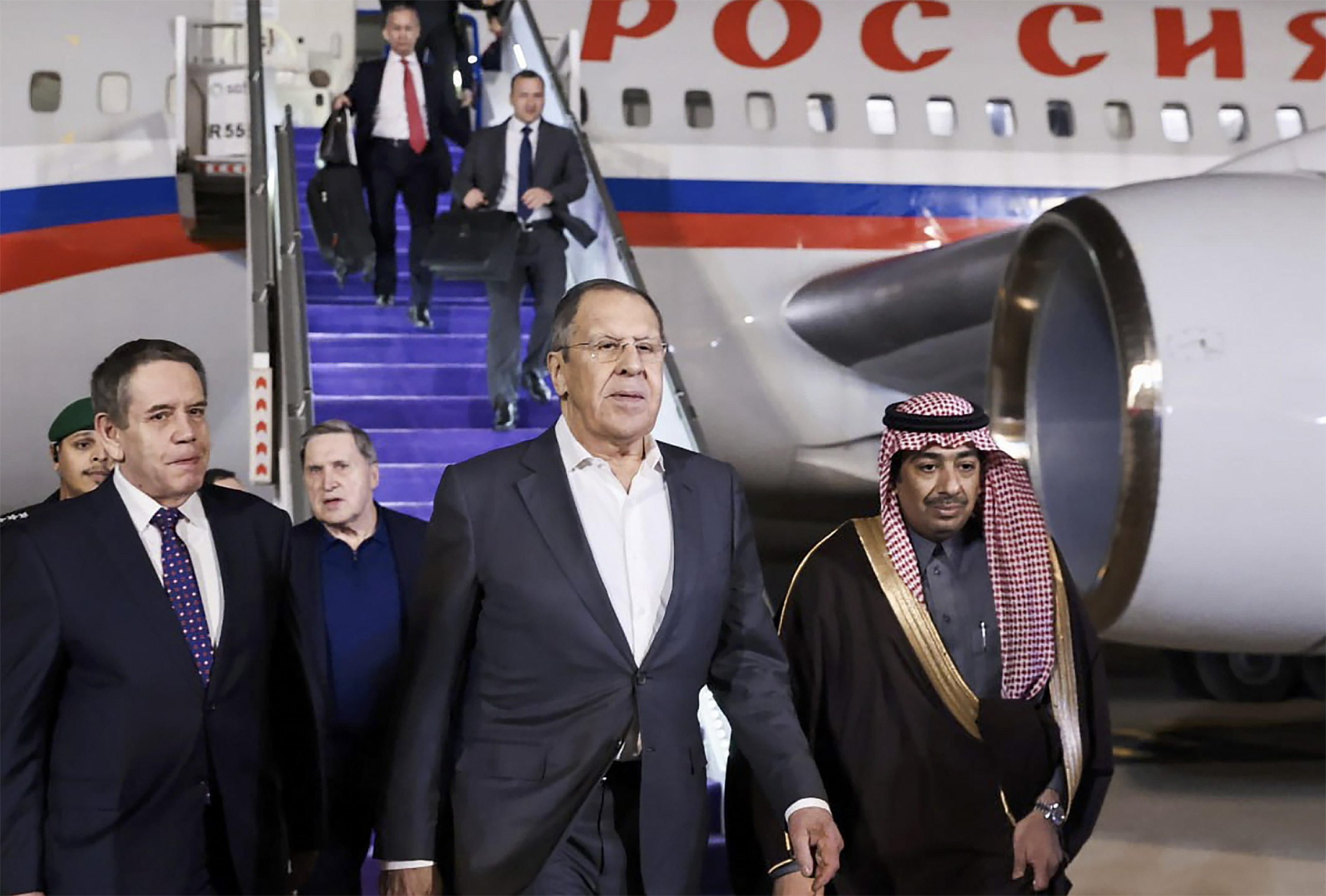 epa11903537 A handout photo made available by the Russian Foreign ministry press service shows Russian Foreign Minister Sergey Lavrov (C) and Russian presidential aide Yury Ushakov (C, back) arriving at the airport of Riyadh, Saudi Arabia, 17 February 2025. The agenda of the meeting of the Russian presidential aide Yuri Ushakov, Russian Foreign Minister Sergey Lavrov with American officials in Riyadh on February 18 is devoted to the restoration of the entire range of bilateral relations, as well as the preparation of possible negotiations on the Ukrainian settlement, the Kremlin reported.  EPA/RUSSIAN FOREIGN MINISTRY PRESS SERVICE HANDOUT HANDOUT EDITORIAL USE ONLY/NO SALES