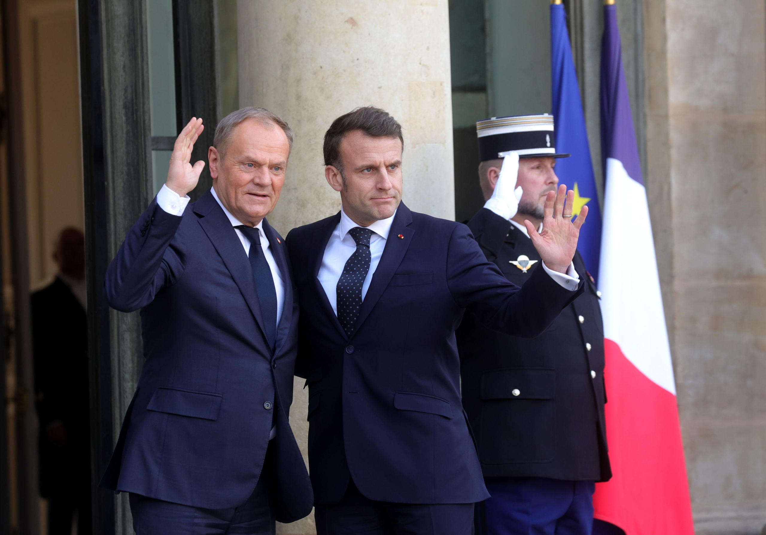 epa11902974 French President Emmanuel Macron (R) welcomes Polish Prime Minister Donald Tusk (L) ahead of a meeting on war in Ukraine and European security at the Elysee Palace in Paris, France, 17 February 2025.  EPA/TERESA SUAREZ