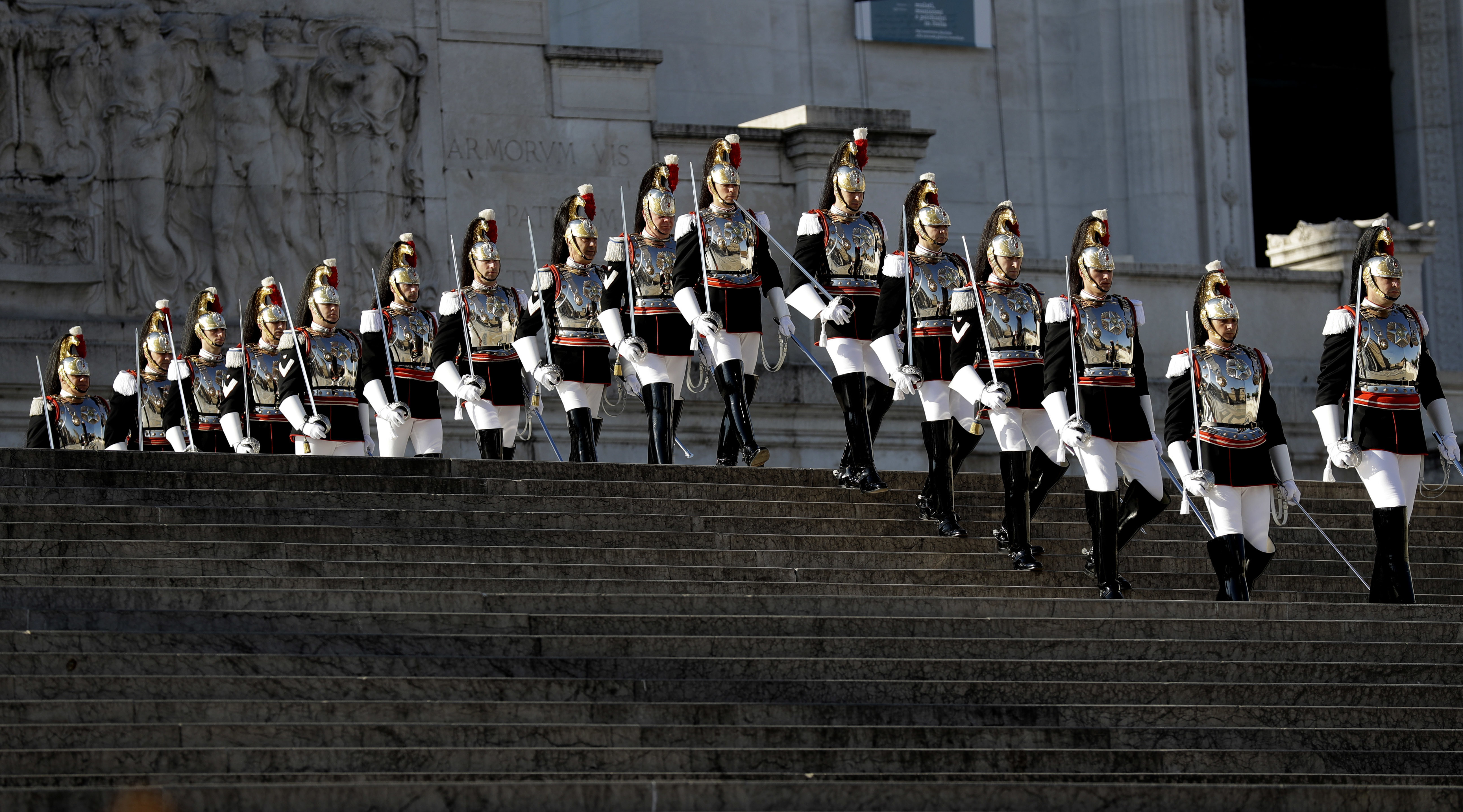 Cuirassier presidential guards descend the steps of the monument to the unknown soldier during a ceremony to mark Italy's Liberation day, in Rome, Tuesday, April 25, 2017. Italy is celebrating the anniversary of a partisan uprising against the Nazis and their Fascist allies at the end of World War II. (AP Photo/Alessandra Tarantino)