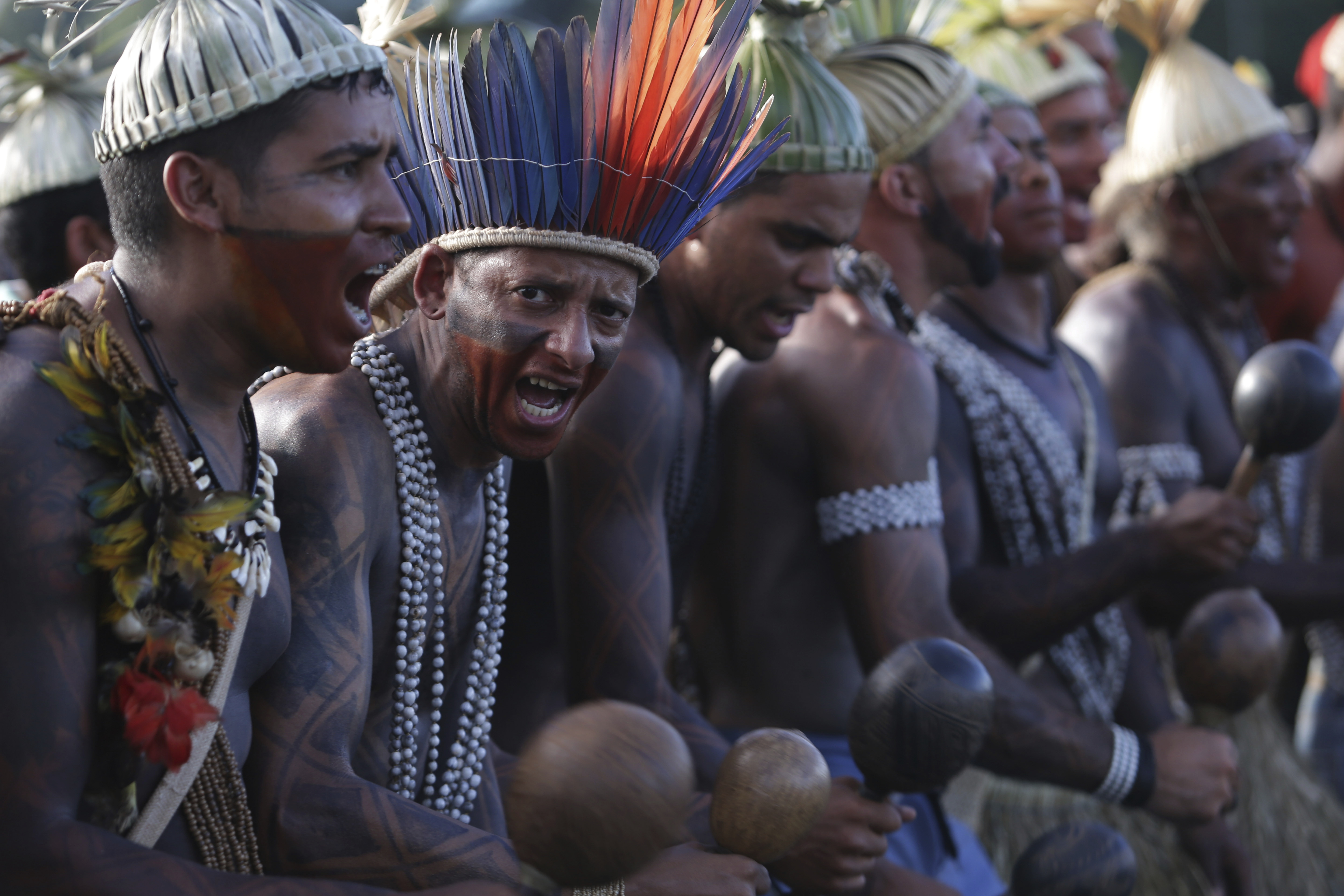 Indigenous people sing and dance during the Indigenous Peoples Ritual March in Brasilia, Brazil, Thursday, April 27, 2017. Indigenous leaders say the government of President Michel Temer is working to roll back protections in various parts of the Amazon and allowing ranchers and other big-money interest to steal their lands. (AP Photo/Eraldo Peres)