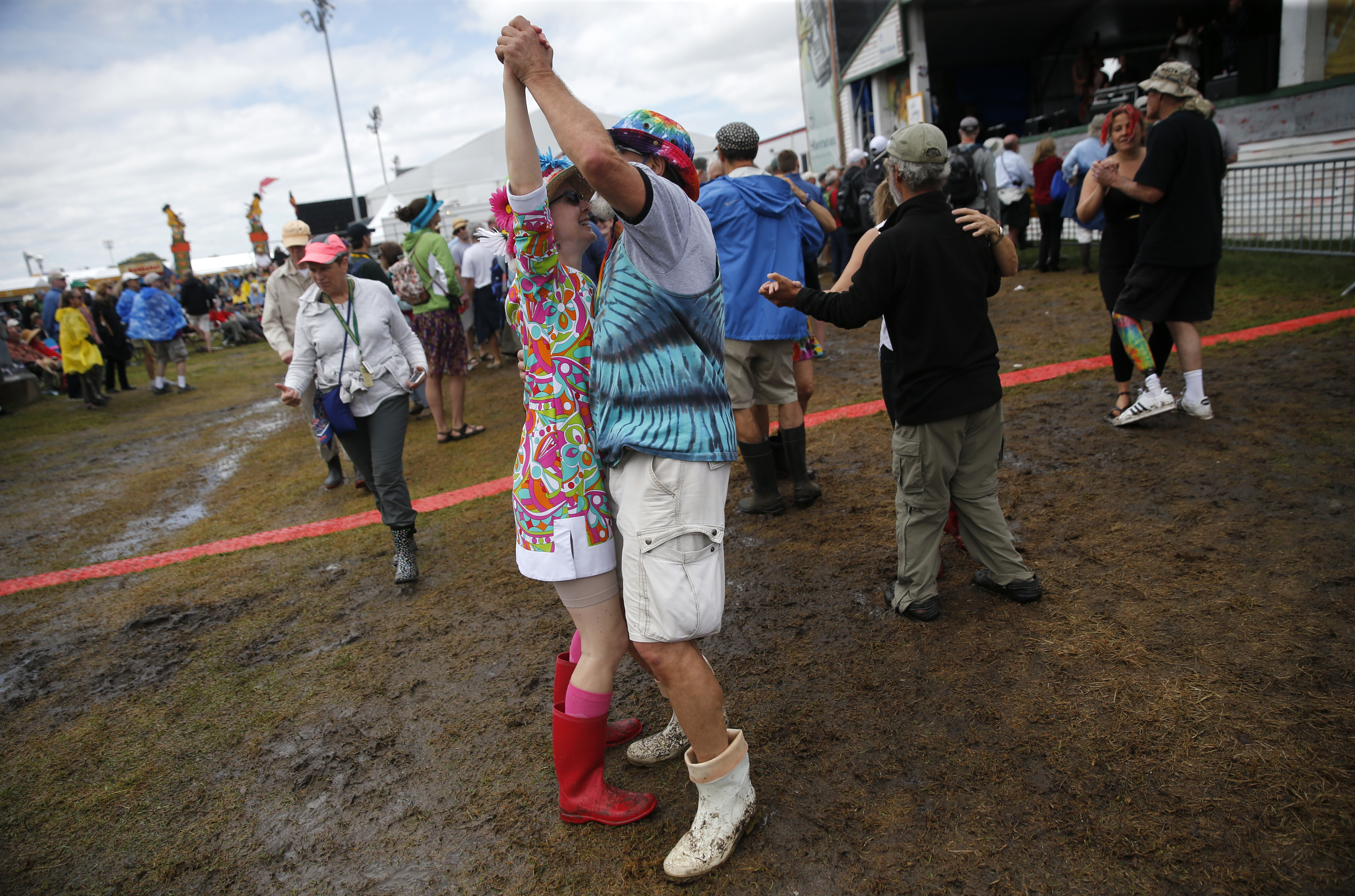 A couple dances in shrimp boots as Yvette Landry performs at the Fais Do-Do stage at the New Orleans Jazz and Heritage Festival in New Orleans, Thursday, May 4, 2017. (AP Photo/Gerald Herbert)