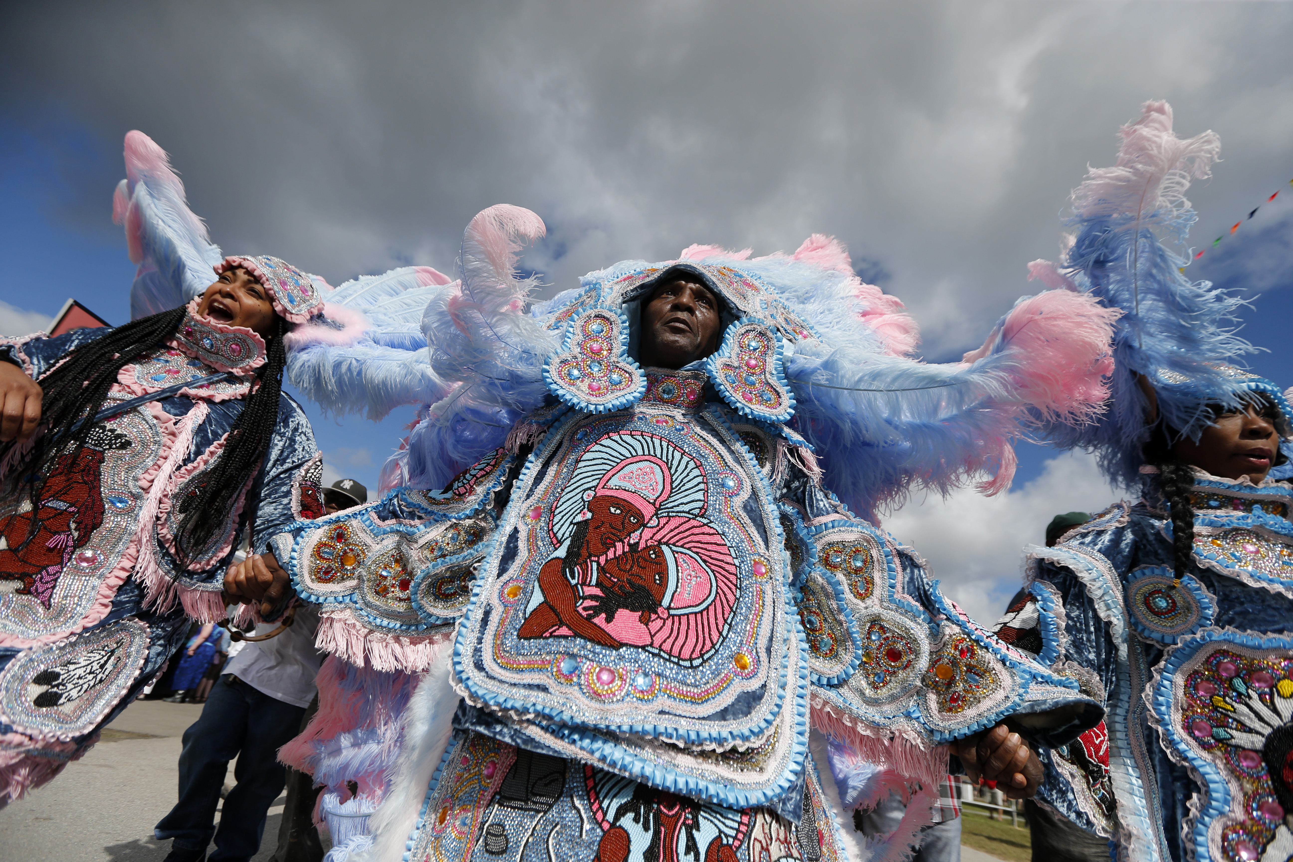 The Cheyenne and 7th Ward Creole Hunters Mardi Gras Indians second line through the crowd at the New Orleans Jazz and Heritage Festival in New Orleans, Thursday, May 4, 2017. (AP Photo/Gerald Herbert)