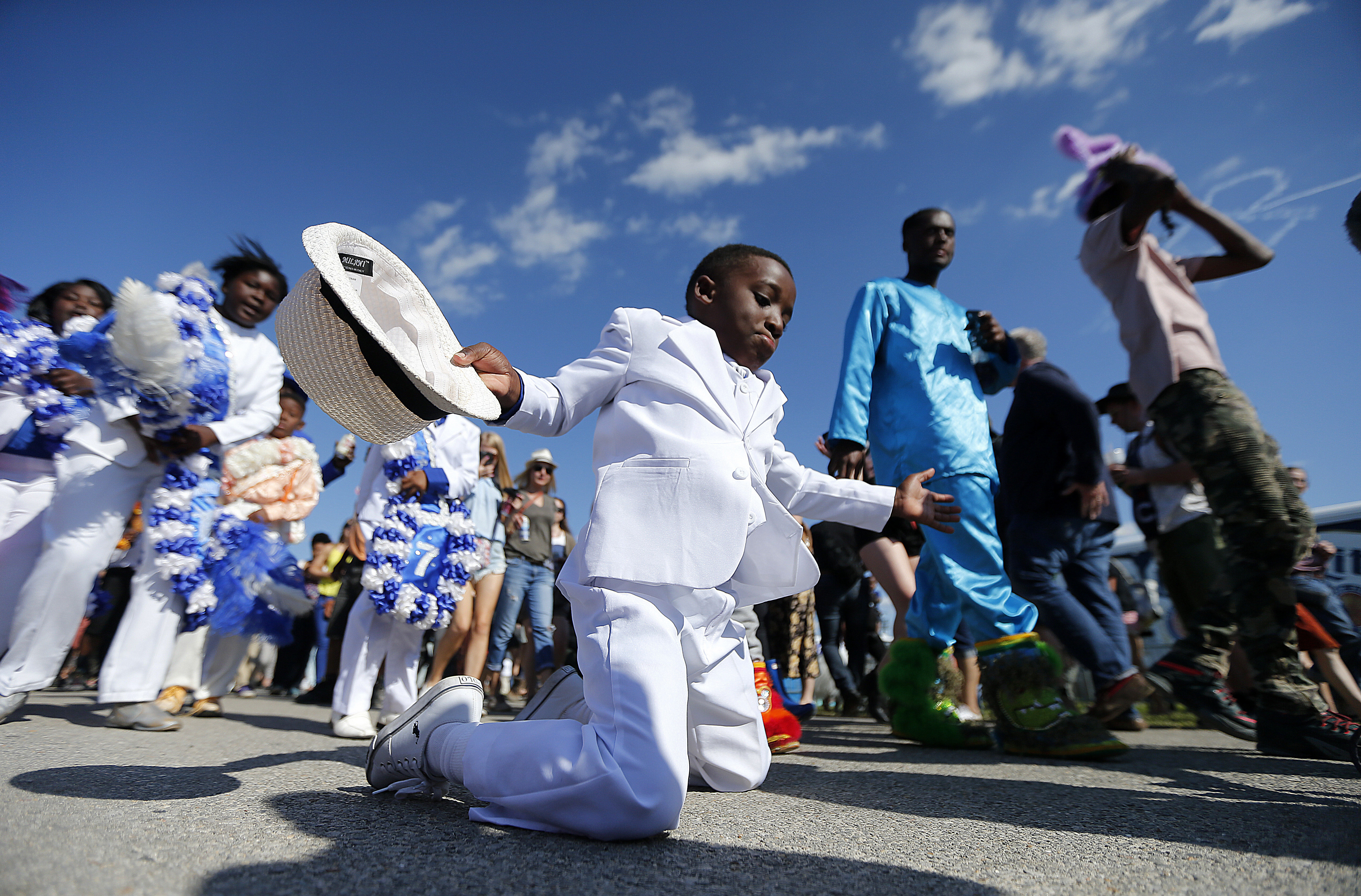 Young members of the Original Big Seven Junior Steppers dance during a second line at the New Orleans Jazz and Heritage Festival in New Orleans, Friday, May 5, 2017. (AP Photo/Gerald Herbert)