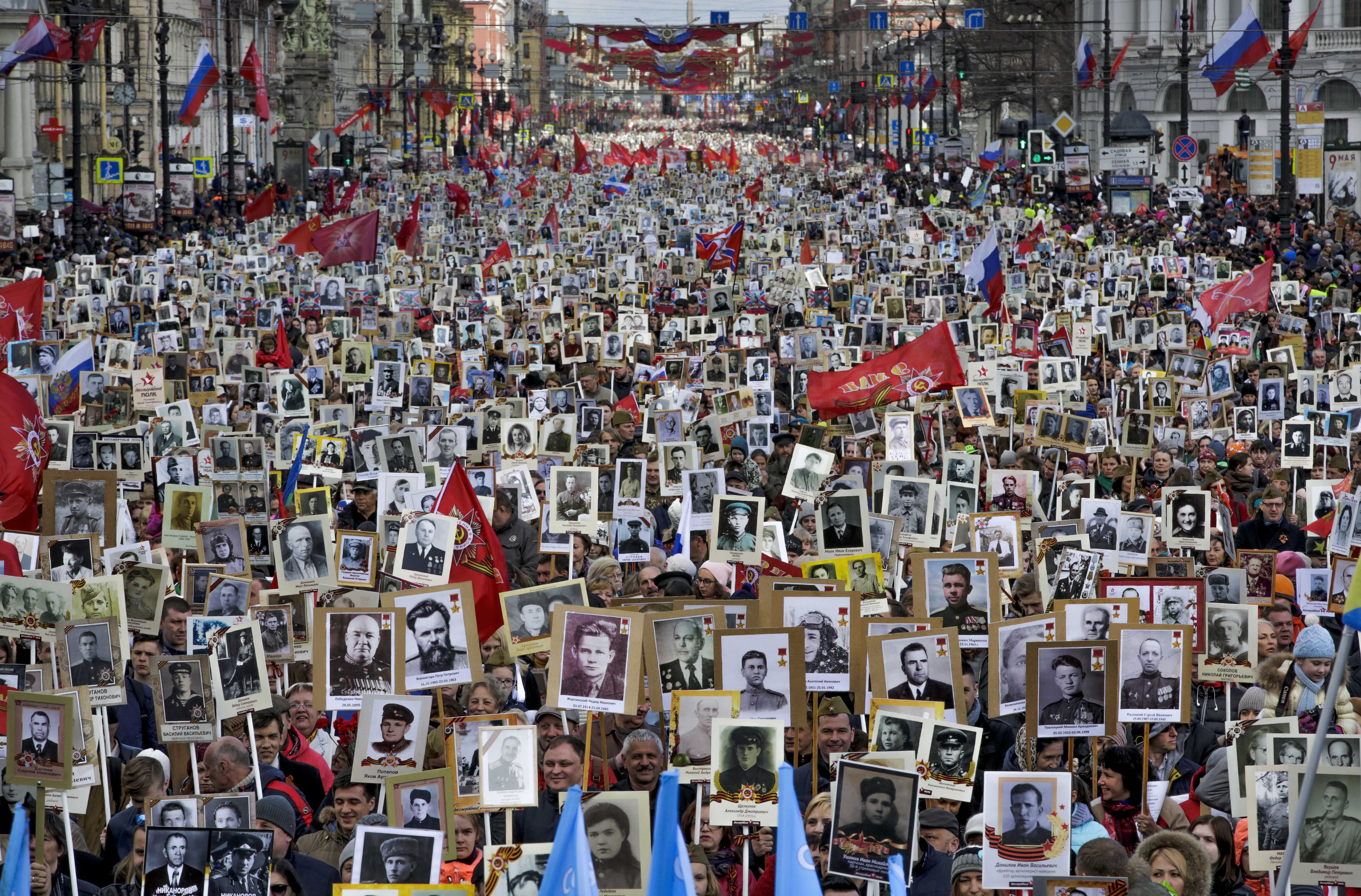 Local residents carry portraits of their ancestors, participants in World War II as they celebrate the 72nd anniversary of the defeat of the Nazis in World War II in St. Petersburg, Russia, on Tuesday, May 9, 2017. About 400,000 people walked in central streets of St. Petersburg in a march named 'Immortal Regiment' while carrying portraits of their relatives who fought in World War II. (AP Photo/Dmitri Lovetsky)
