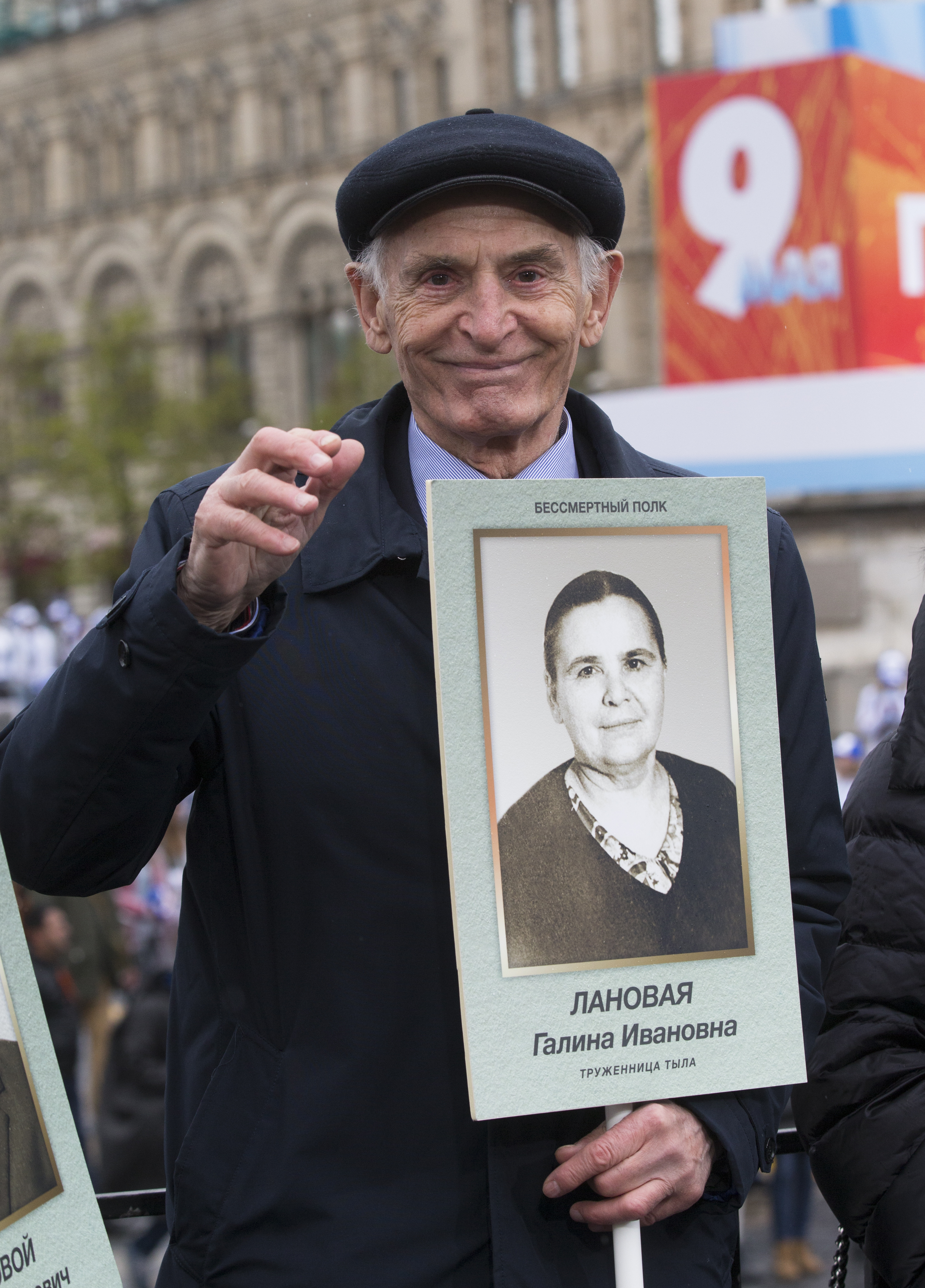 Russian actor Vasily Lanovoy holds a portrait of his mother during the Immortal Regiment march in Moscow's Red Square, Russia, May 9, 2017, celebrating 72 years since the end of WWII and the defeat of Nazi Germany. (AP Photo/Alexander Zemlianichenko)