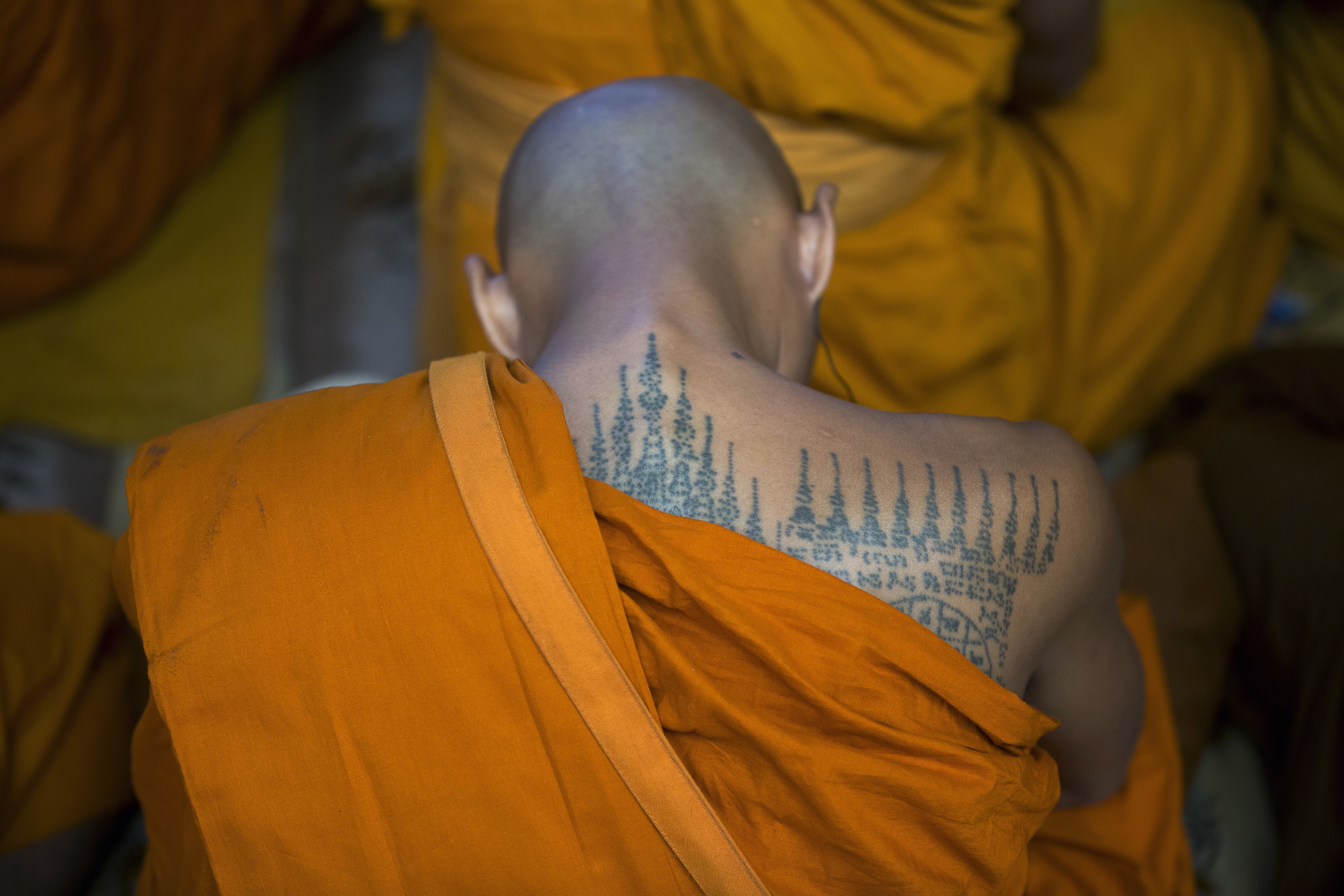 A Thai Buddhist monk with a tattooed back prays as he listens to the Tibetan spiritual leader Dalai Lama during a religious talk at the Tsuglagkhang temple in Dharmsala, India, Wednesday, June 7, 2017. Each year the Tibetan leader talks to young Tibetans on Buddhist philosophy and selected texts. The three-day talk ended Wednesday. (AP Photo/Ashwini Bhatia)