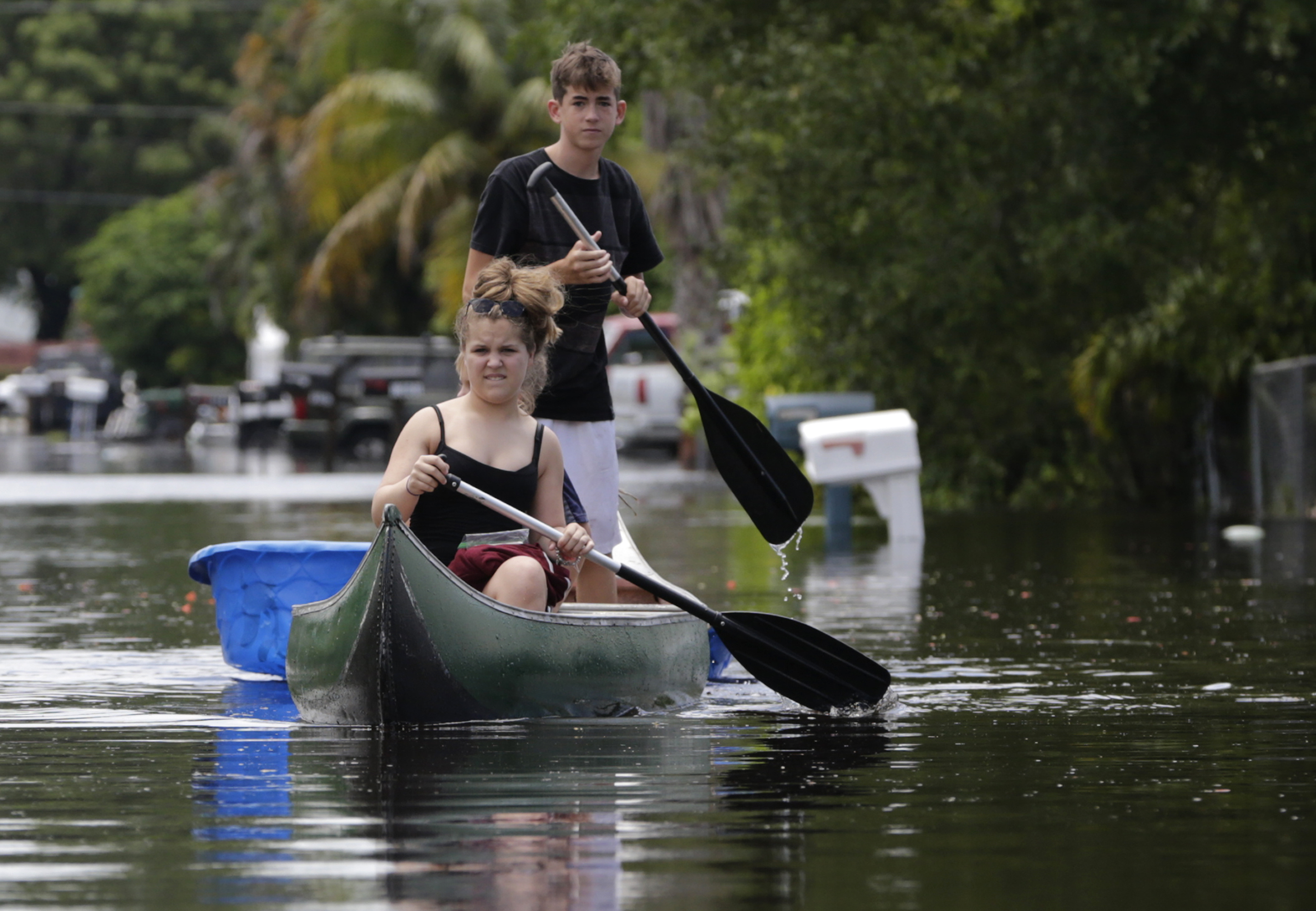Isabella and Timothy, who did not want their last names used, navigate flooded streets following heavy rains, Wednesday, June 7, 2017, in Davie, Fla. Several South Florida cities set rainfall records as heavy rain continues to fall, bringing the potential for further flooding. Wallace put up the 