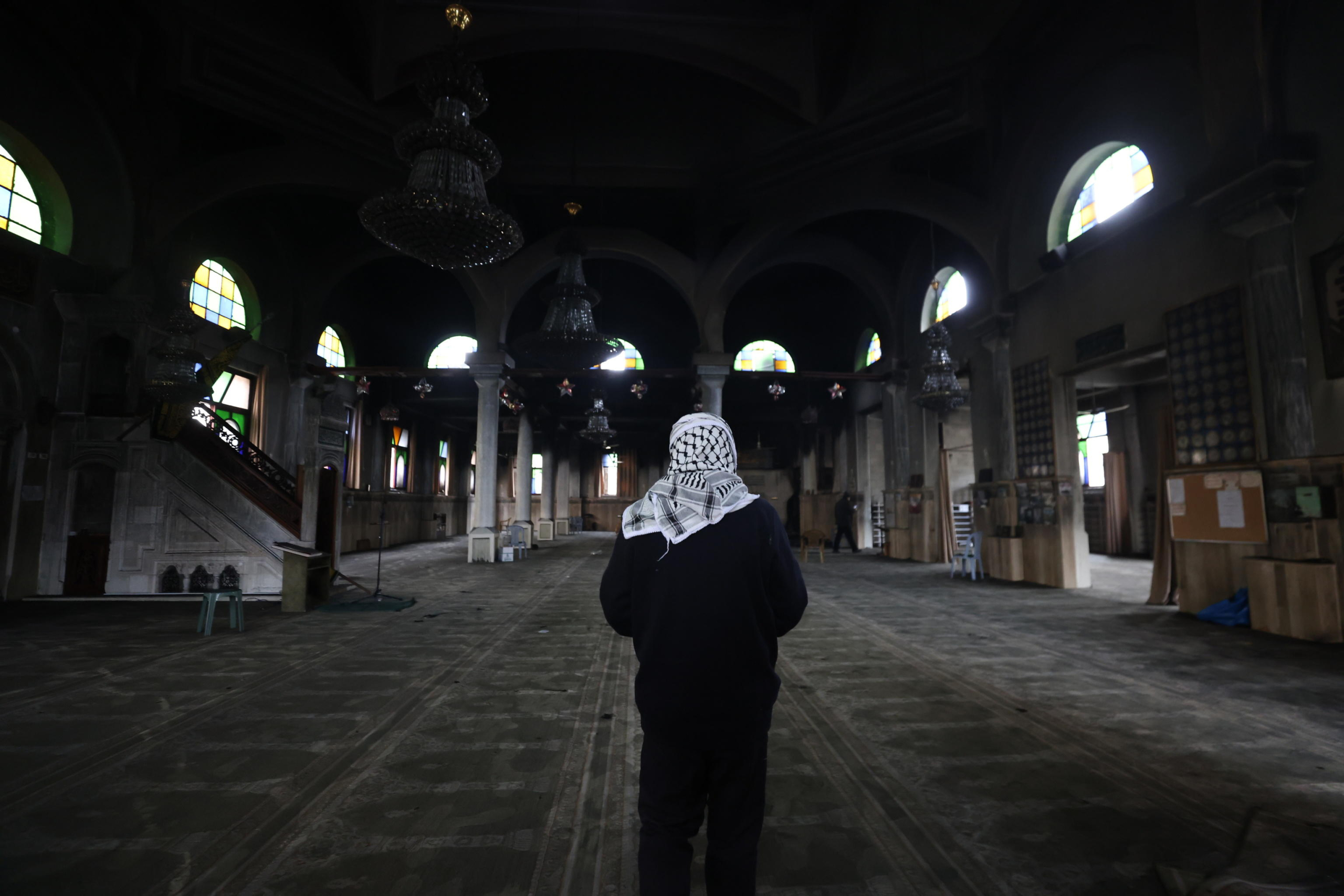 epa11946452 A Palestinian man inspects the damage inside Al-Nasr Mosque, following an Israeli military raid in the old city of Nablus, West Bank, 07 March 2025. According to the Palestinian news agency Wafa, Israeli military forces raided several mosques in the old city of Nablus at dawn on 07 March, and set the Al-Nasr Mosque on fire.  EPA/ALAA BADARNEH