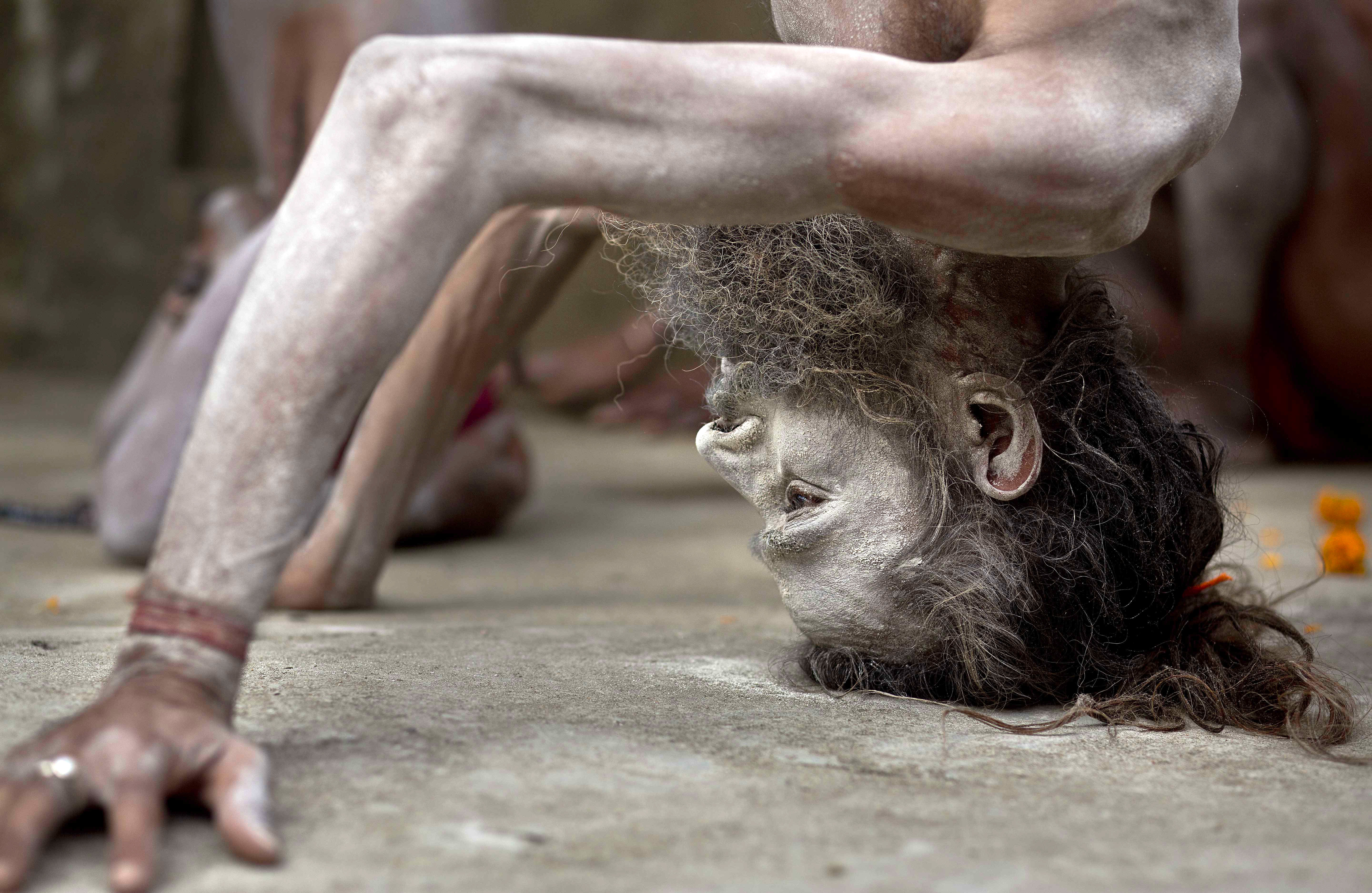 An Indian Sadhu or Hindu holy man performs Yoga to mark International Yoga Day at Kamakhya temple in Gauhati, India, Wednesday, June 21, 2017. Millions of yoga enthusiasts across India take part in a mass yoga sessions to mark the third International Yoga Day which falls on June 21 every year. (AP Photo/ Anupam Nath)