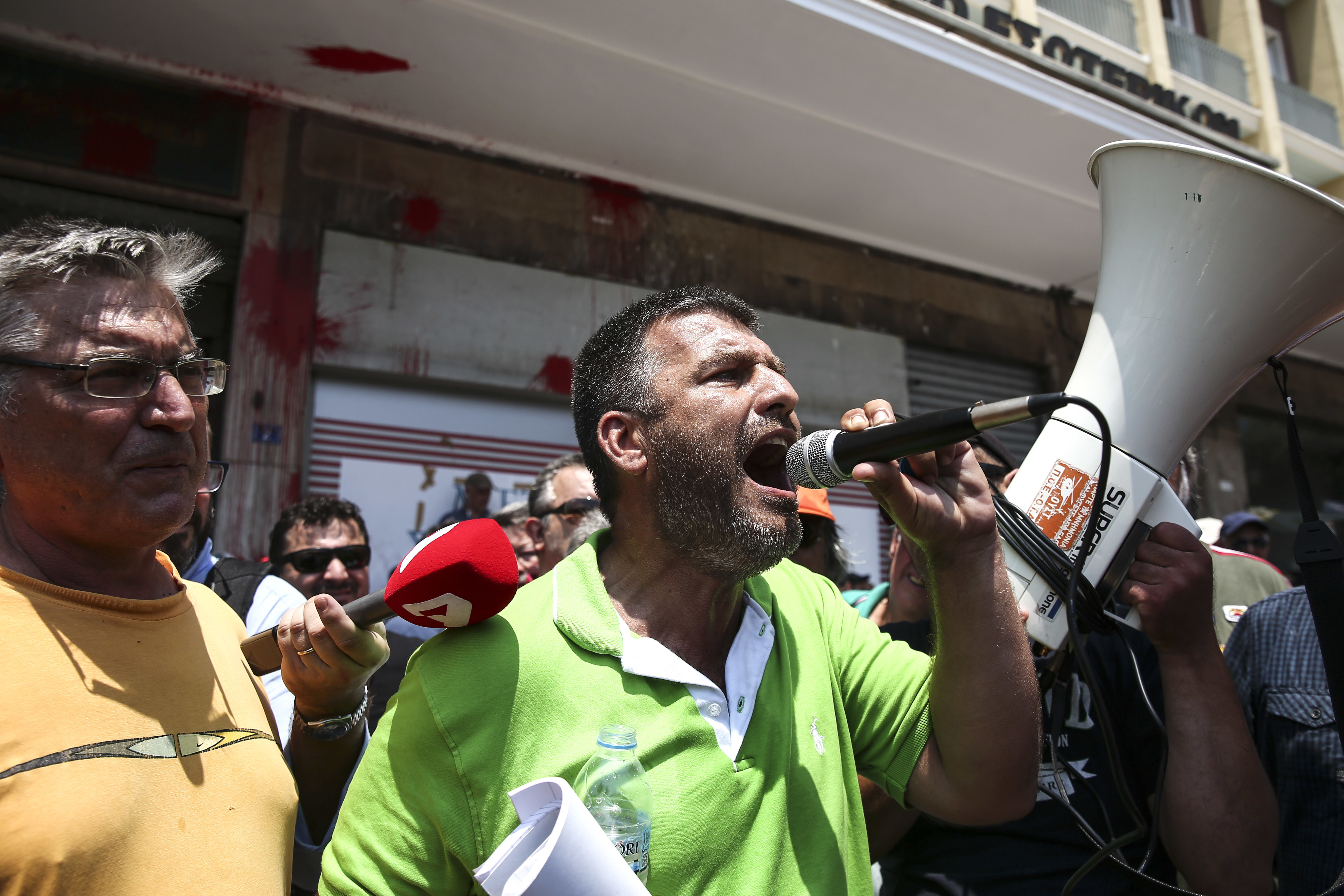 Nikos Trikas, leader of the municipal workers union, speaks to his colleagues during a rally outside the Interior Ministry in Athens, on Monday, June 26, 2017. With a heat wave expected later this week, Greece's government Monday urging striking garbage collectors to return to work after a 10-day protest has left huge piles of trash around Athens. (AP Photo/Yorgos Karahalis)