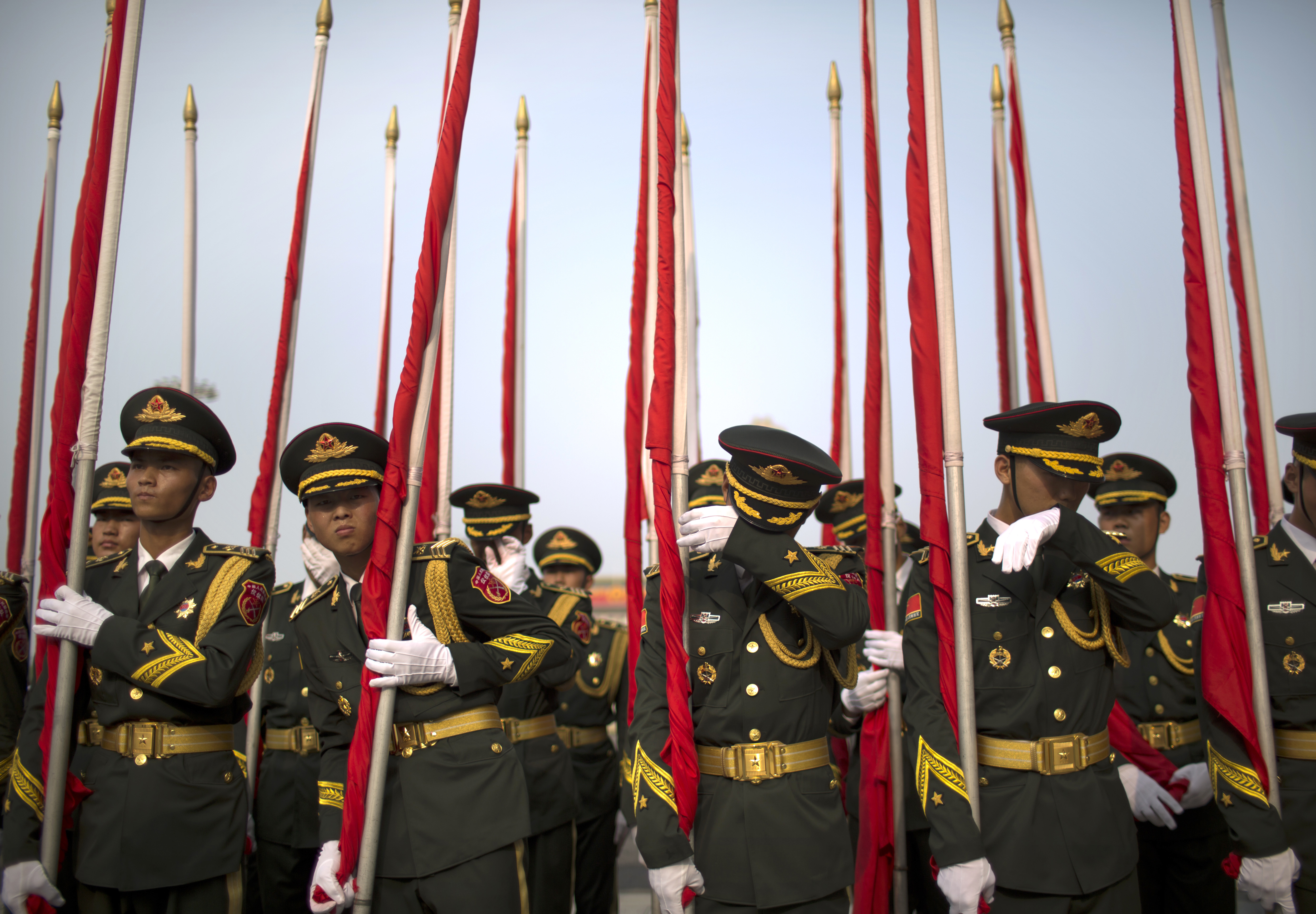 Members of a Chinese honor guard wipe sweat off of their faces before a welcome ceremony for Palestinian President Mahmoud Abbas at the Great Hall of the People in Beijing, Tuesday, July 18, 2017. (AP Photo/Mark Schiefelbein)