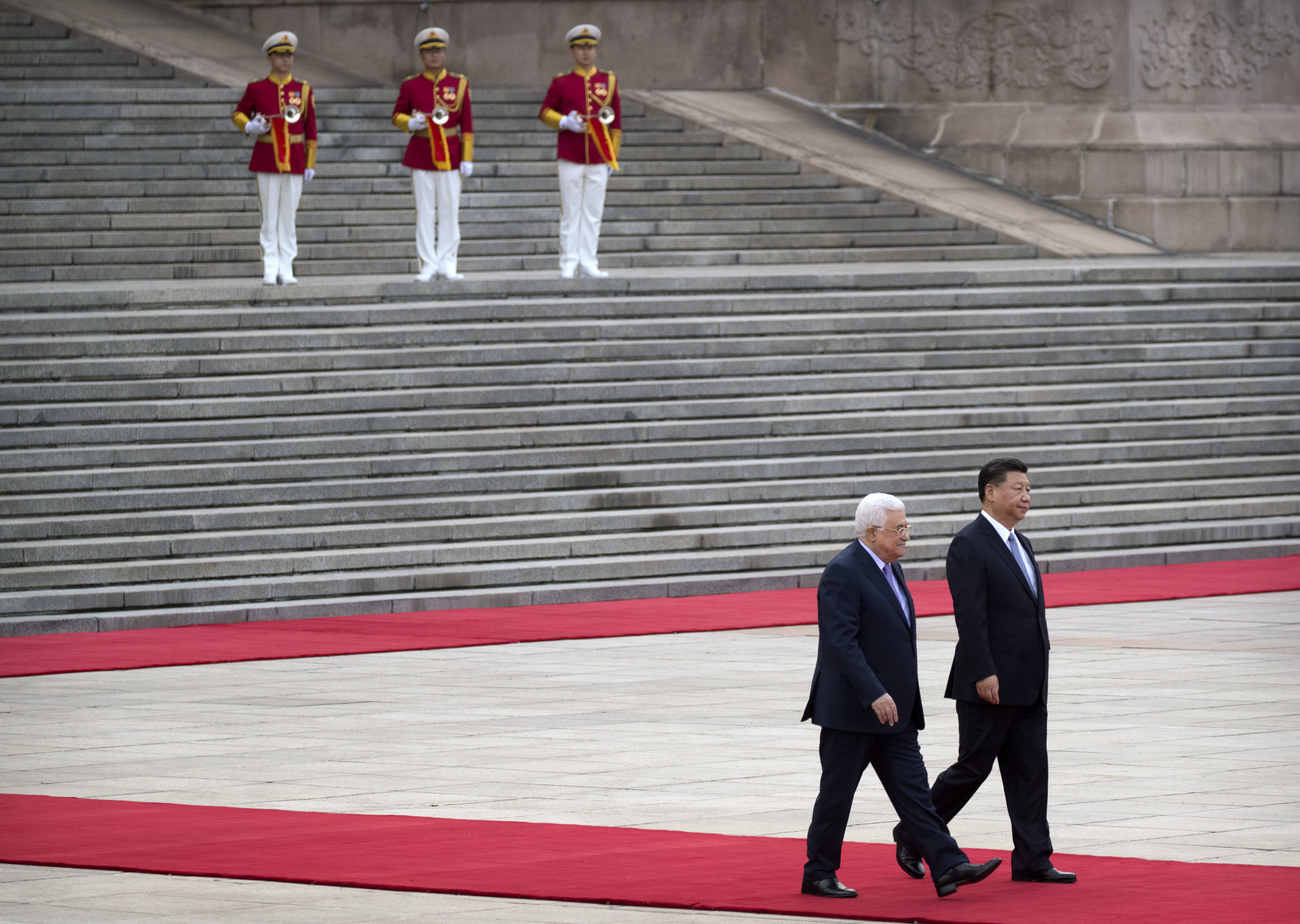 Palestinian President Mahmoud Abbas, left, and Chinese President Xi Jinping walk together during a welcome ceremony at the Great Hall of the People in Beijing, Tuesday, July 18, 2017. (AP Photo/Mark Schiefelbein)