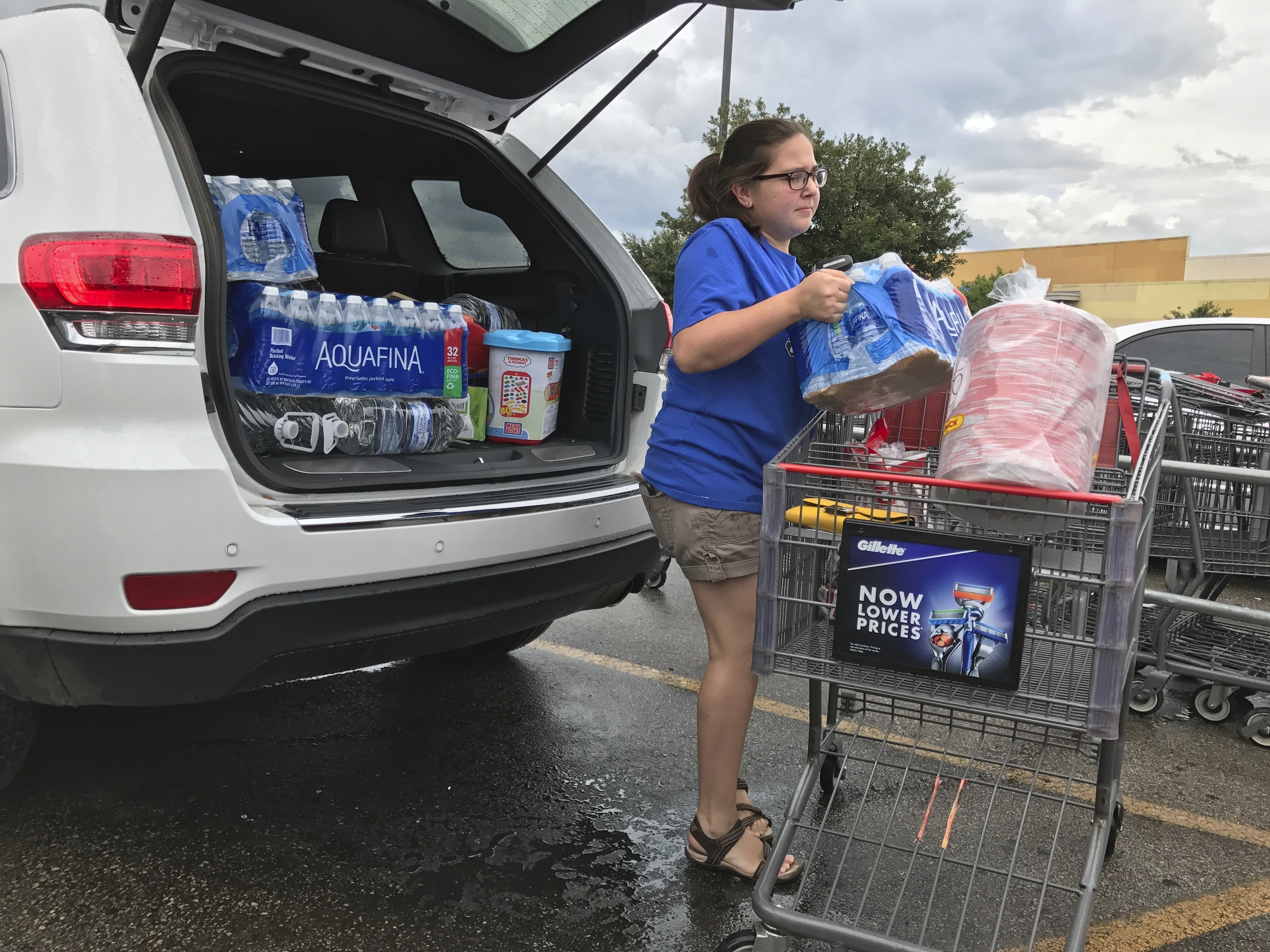 Stephanie Locke stocks up on water at H-E-B on Riverside Drive in Austin, Texas, in preparation for severe weather expected to hit central Texas connected to Hurricane Harvey. (James Gregg/Austin American-Statesman via AP)