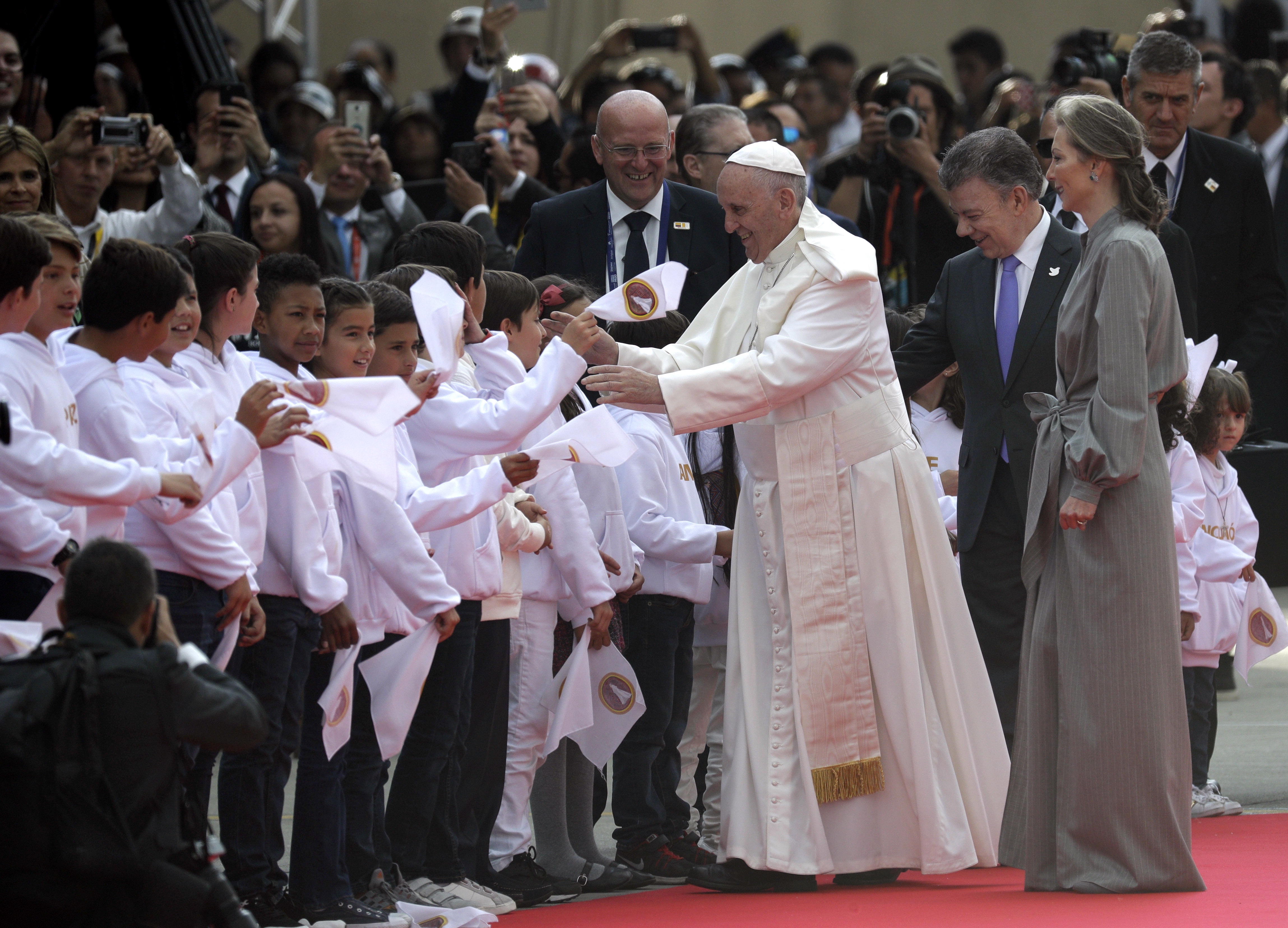 Colombia’s President Juan Manuel Santos, second from right,  and wife Maria Clemencia Rodriguez accompany Pope Francis as he is greeted by Colombian children after his arrivalat El Dorado airport in Bogota, Colombia, Wednesday, Sept. 6, 2017. Pope Francis arrived in Colombia for a five-day visit. (AP Photo/Andrew Medichini)