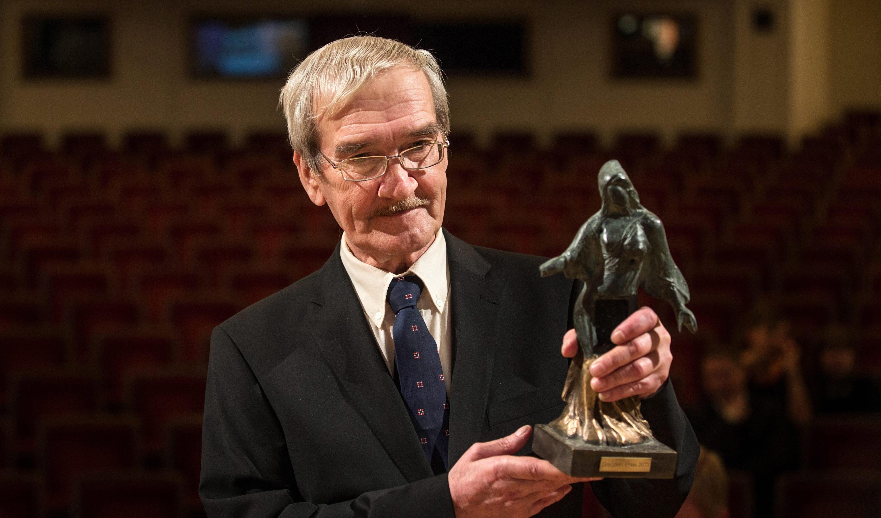 epa03588336 Former Soviet officer Stanislav Petrov holds the Dresden Prize at the Semper Opera, in Dresden, Germany, 17 February 2013. The prize presented by the organization Friends of Dresden is endowed with 25,000 euros. The 73-year-old former Russian soldier is credited with preventing a nuclear war on 26 September 1983. He judged an early warning system that erroneously detected a missile launch from the United States to be a false alarm and thereby is thought to have averted a nuclear holocaust.  EPA/OLIVER KILLIG