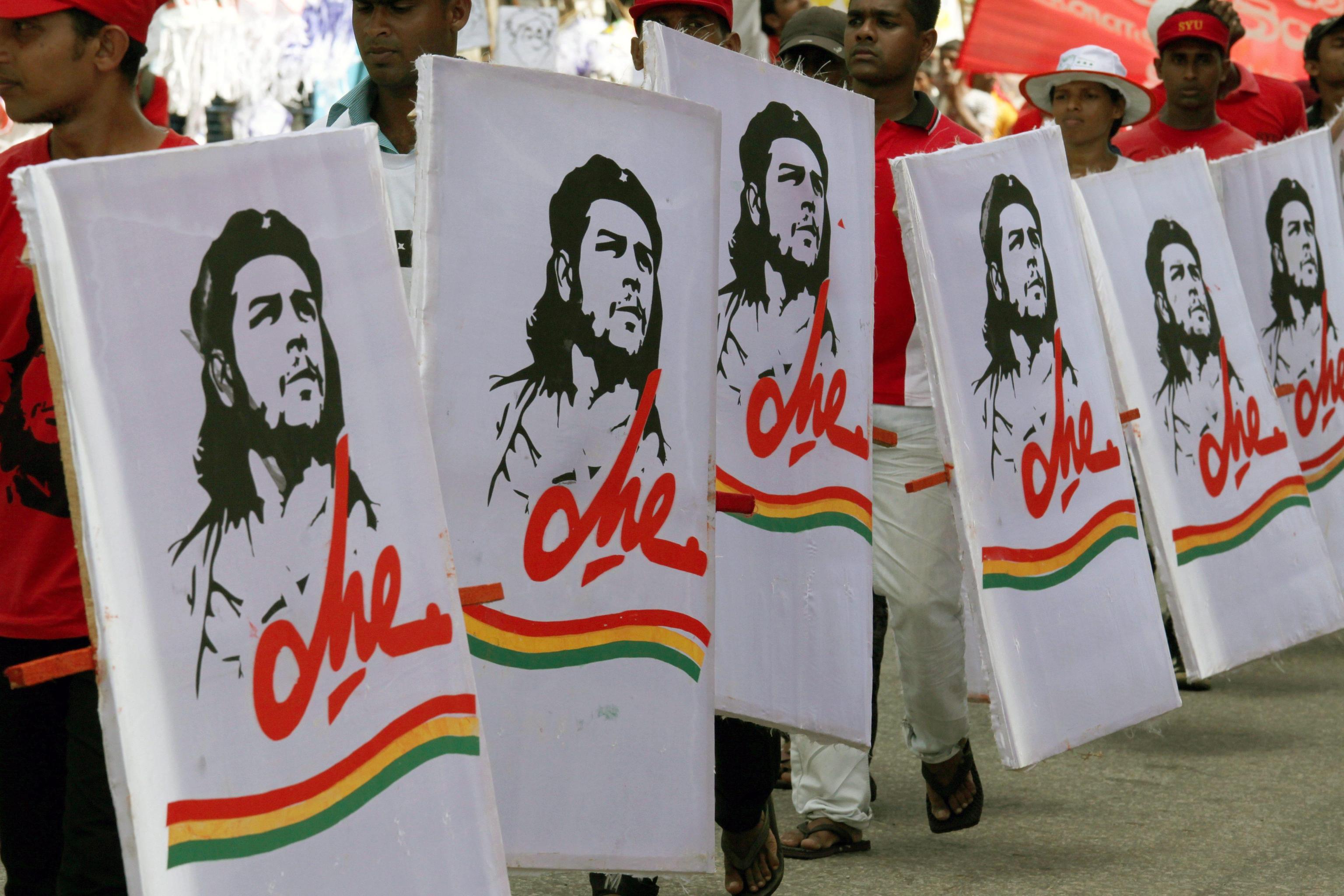 epa03202863 Janatha Vimukthi Peramuna or People's Liberation Front cadres carry portraits of Che Guevara during the May Day parade to the BRC Grounds in Colombo, Sri Lanka, 01 May 2012. Perhaps the only Marxist party in the island nation, the Janatha Vimukthi Peramuna or People's Liberation Front founded by Rohana Wijeweera who was killed after his second failed rebellion during 1988-89 has been in and out of governments after it entered mainstream politics. It suffered a split recently which gave birth to another political entity the Frontline Socialist Party.  EPA/M.A.PUSHPA KUMARA