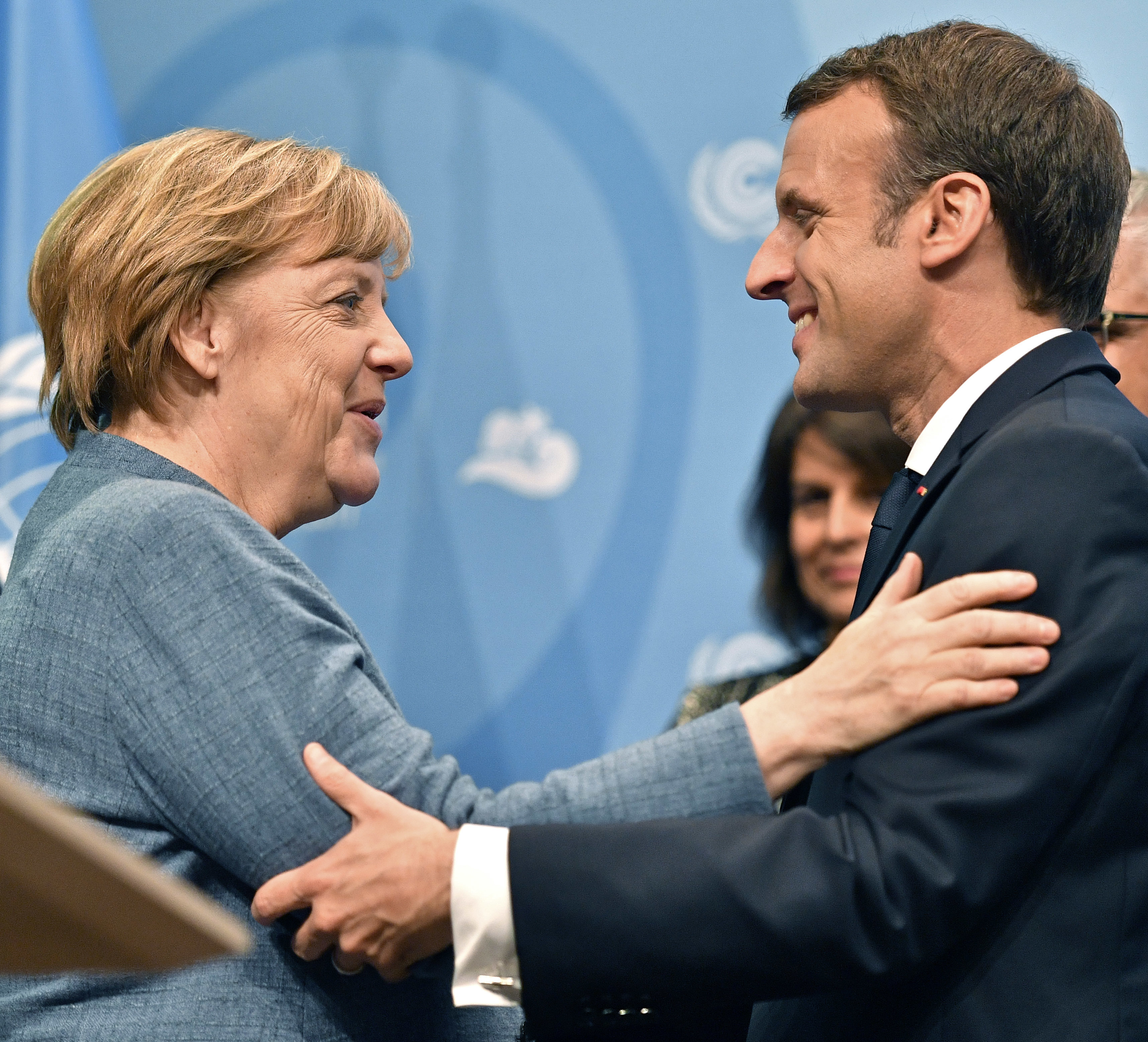 German Chancellor Angela Merkel, left, welcomes French President Emmanuel Macron during the 23rd Conference of the Parties (COP) climate talks in Bonn, Germany, Wednesday, Nov. 15, 2017. World leaders arrive at the global climate talks in Germany on Wednesday to give the negotiations a boost going into the final stretch. (AP Photo/Martin Meissner)