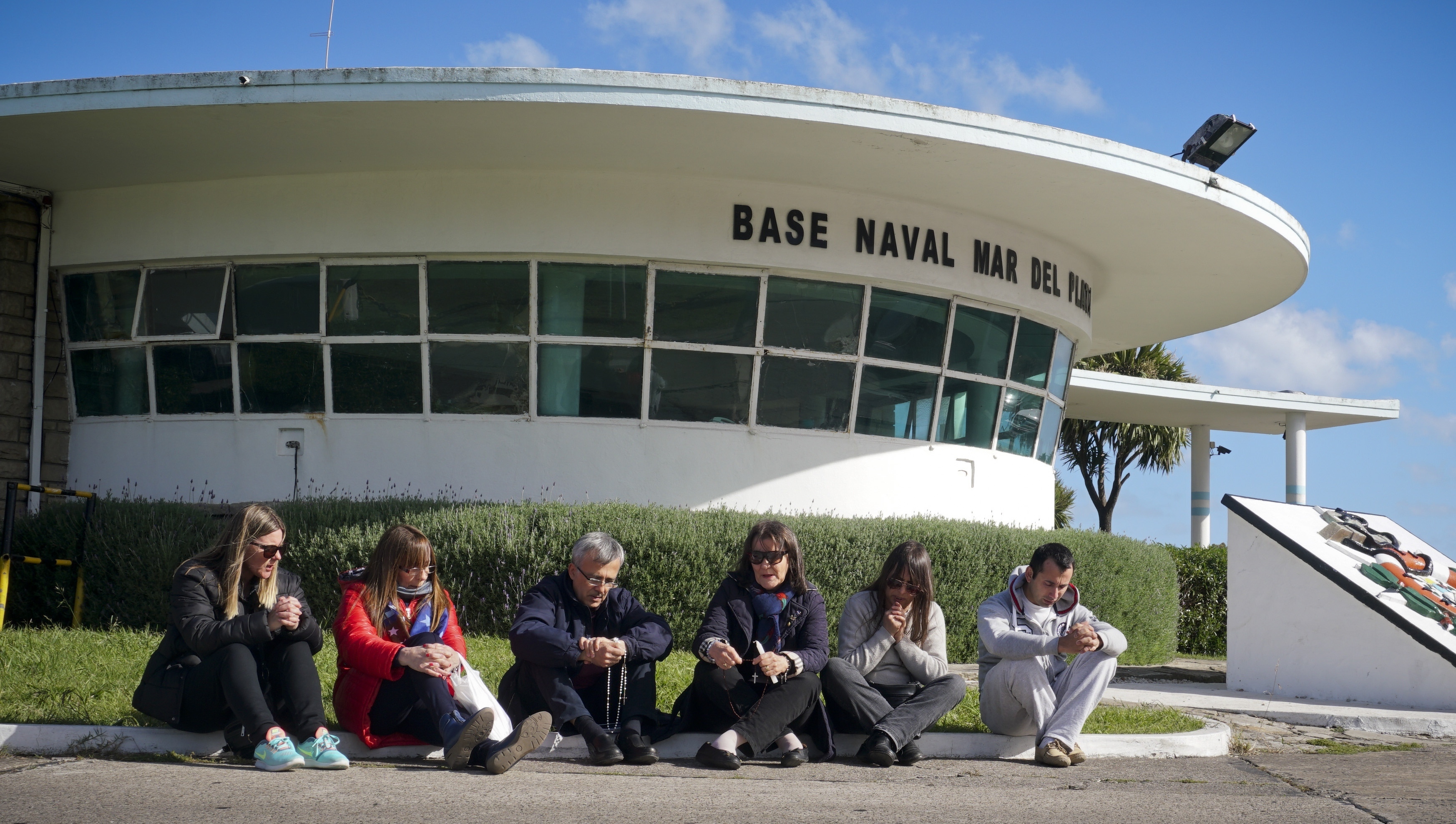 Families of the 44 crew members of the missing Argentine submarine ARA San Juan pray outside the Mar del Plata Naval Base, in Argentina, Tuesday, Nov. 21, 2017. The search continues for the missing submarine that has been lost since Nov. 15 in the South Atlantic. (AP Photo/Paul Byrne)