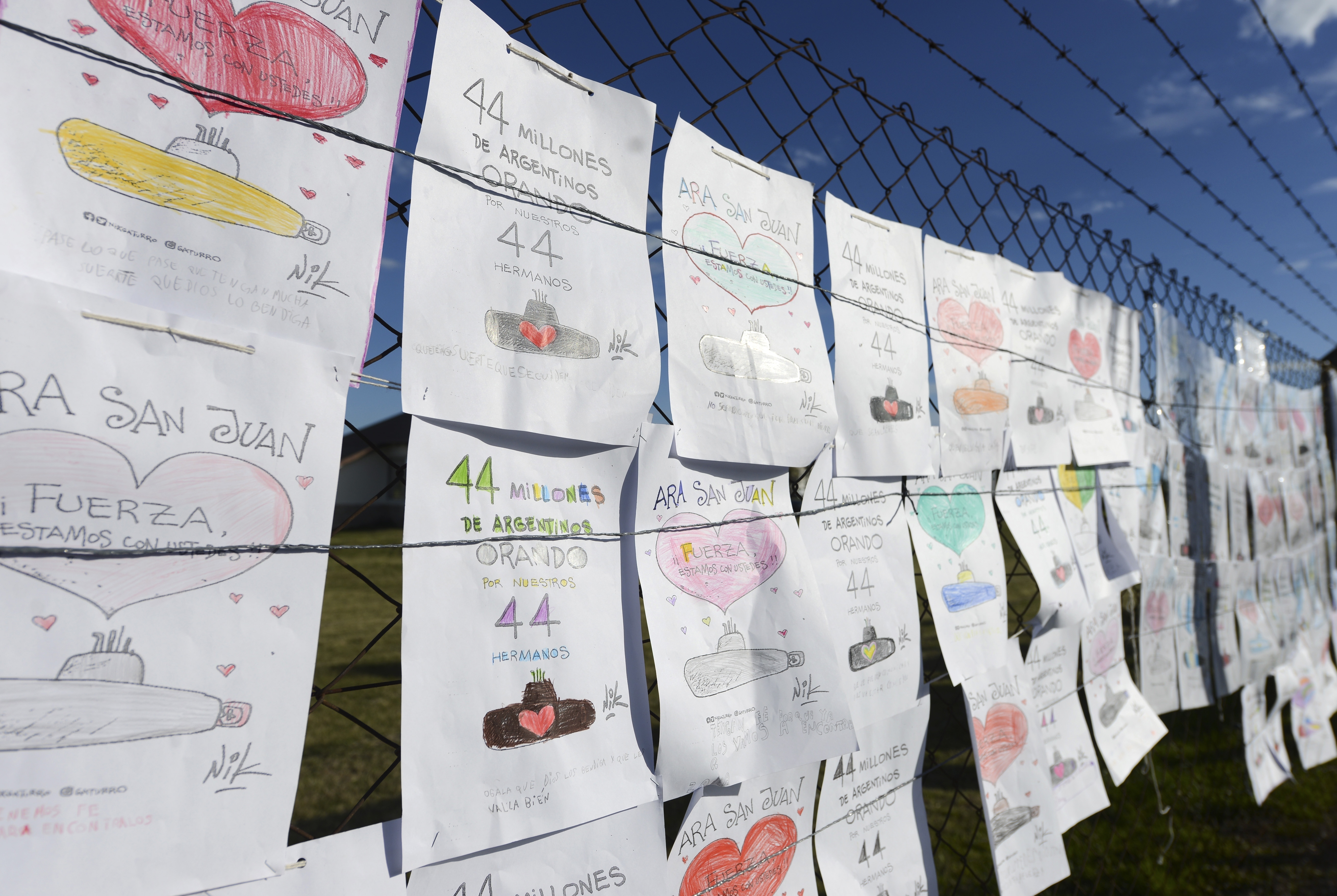 Drawings by children in support of the crew of the missing submarine ARA San Martin, hang from the fence of the Mar del Plata Naval Base, in Argentina, Wednesday, Nov. 22, 2017. The families of the 44 crew members aboard a submarine that has been lost in the South Atlantic for seven days are growing increasingly distressed as experts say that the crew might be reaching a critical period of low oxygen. (AP Photo/Marina Devo)