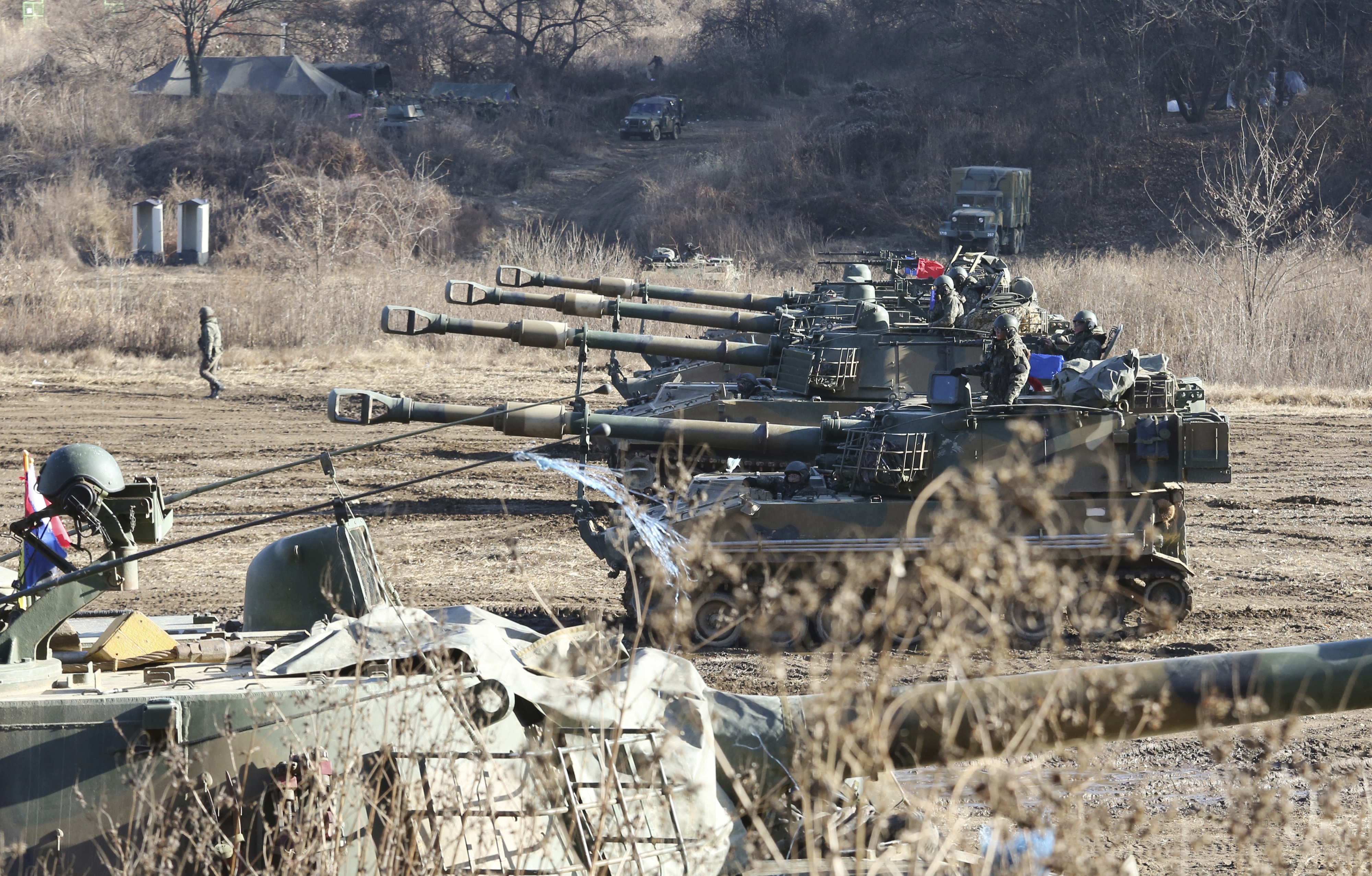 South Korean army soldiers man K-55 self-propelled howitzers during a military exercises in Paju, South Korea, near the border with North Korea, Wednesday, Nov. 29, 2017. After 2 ½ months of relative peace, North Korea launched its most powerful weapon yet early Wednesday, a presumed intercontinental ballistic missile that could put Washington and the entire eastern U.S. seaboard within range. (AP Photo/Ahn Young-joon)