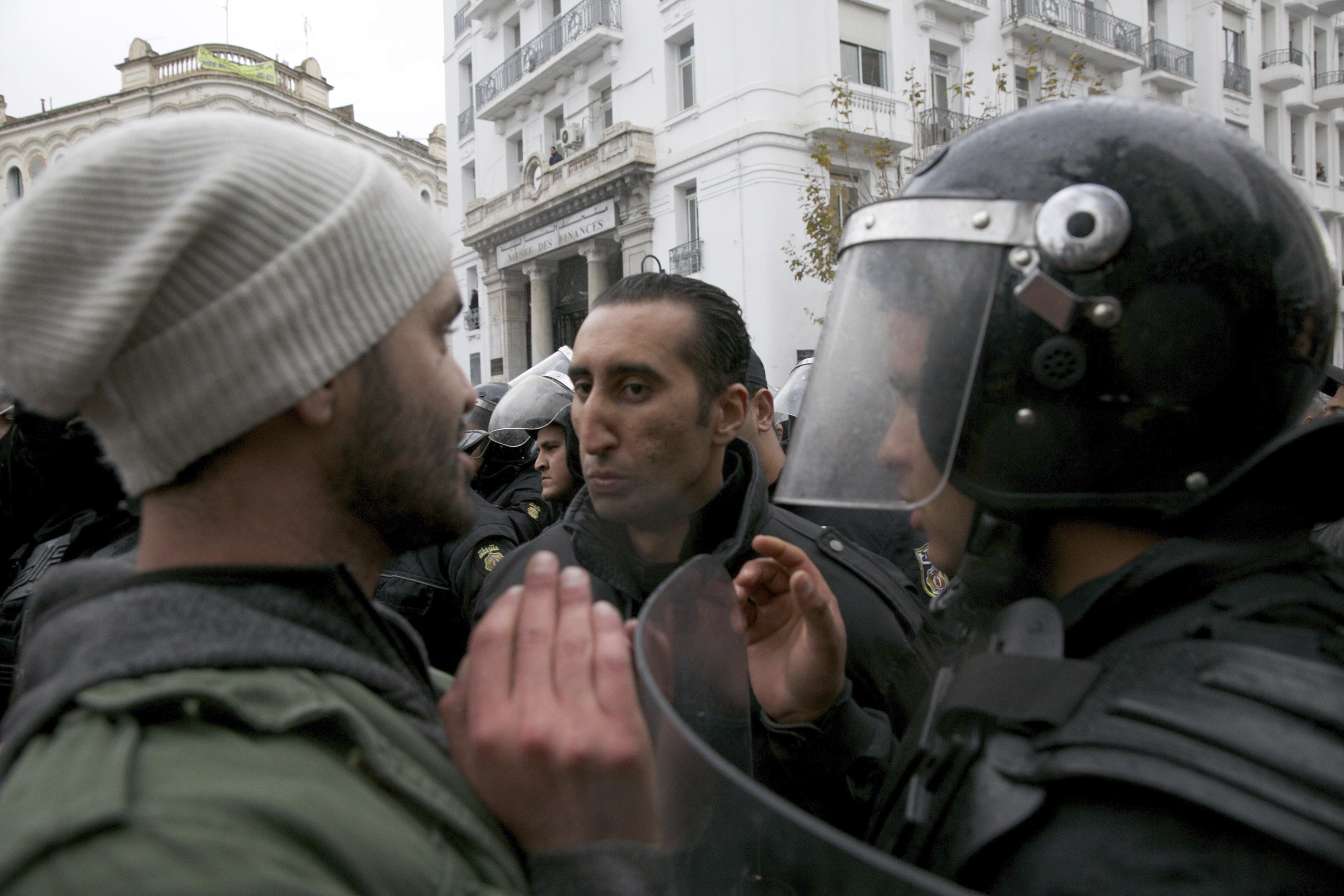 Protestors face riot police during a demonstration in Tunis, Tunisia, Friday Jan. 12, 2018. Tunisia's government says protests appear to be subsiding after anger over food prices led to days of clashes with police that left one dead, dozens injured and widespread damage. (AP Photo/Hassene Dridi)