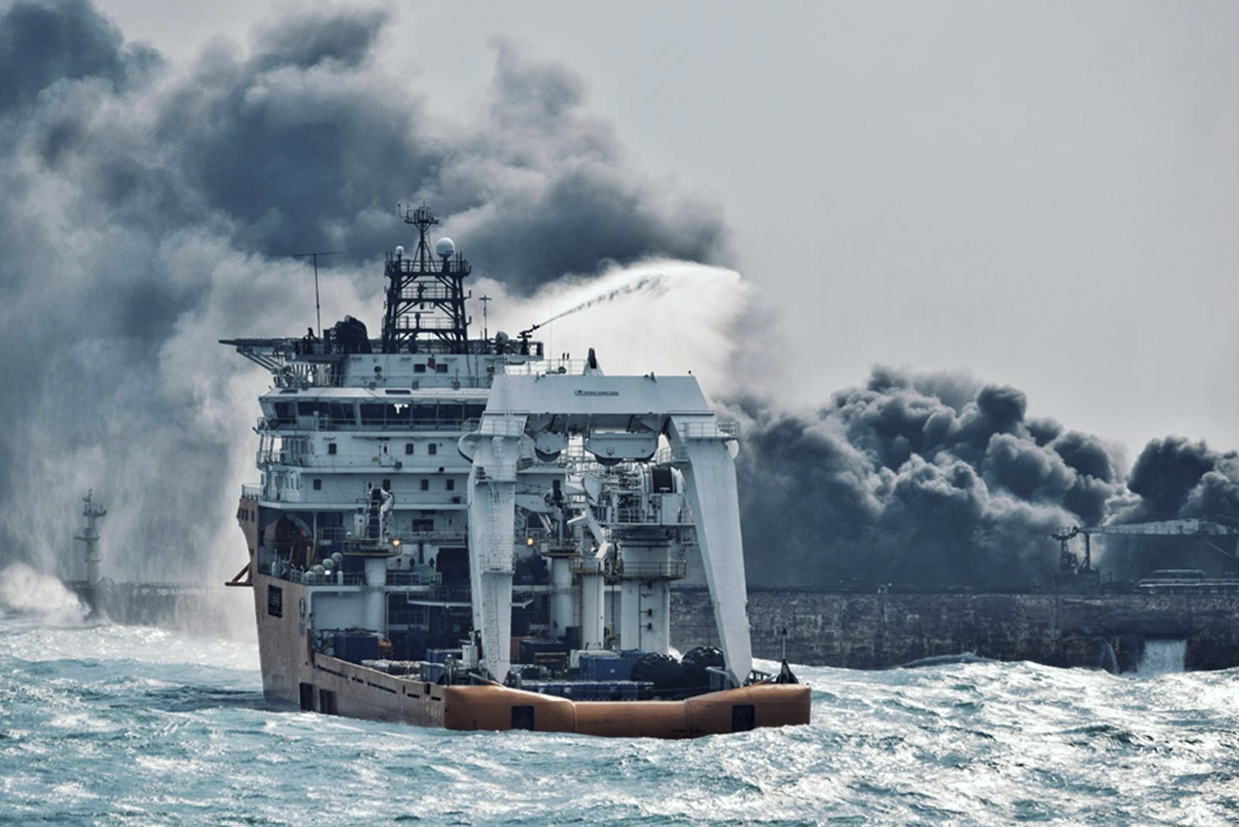 In this Jan. 10, 2018 photo provided by China's Ministry of Transport, a firefighting boat works to put on a blaze on the oil tanker Sanchi in the East China Sea off the eastern coast of China. Rescue ships looking for missing crew members from the oil tanker Sanchi have expanded their search area to more than 2,600 square kilometers (1,000 square miles) as Chinese state television reported Friday that maritime authorities still have not found any survivors, or put out the blaze onboard the ship. (China's Ministry of Transport via AP)