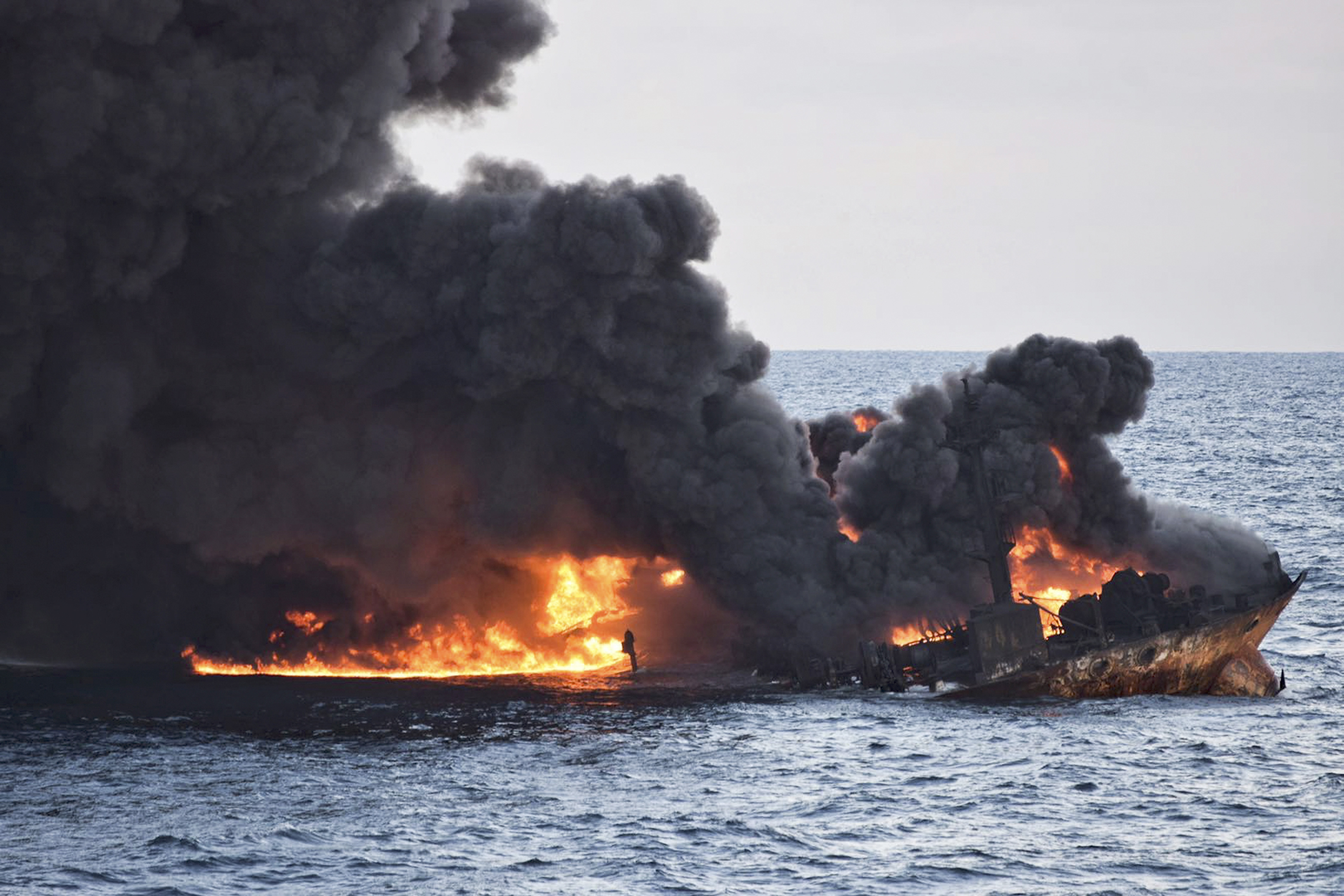 In this Sunday, Jan. 14, 2018 photo provided by China's Ministry of Transport, the burning Iranian oil tanker Sanchi is seen partially sunk in the East China Sea off the eastern coast of China. The fire from the sunken Iranian tanker ship in the East China Sea has burned out, a Chinese transport ministry spokesman said Monday, although concerns remain about possible major pollution to the sea bed and surrounding waters. (Ministry of Transport via AP)