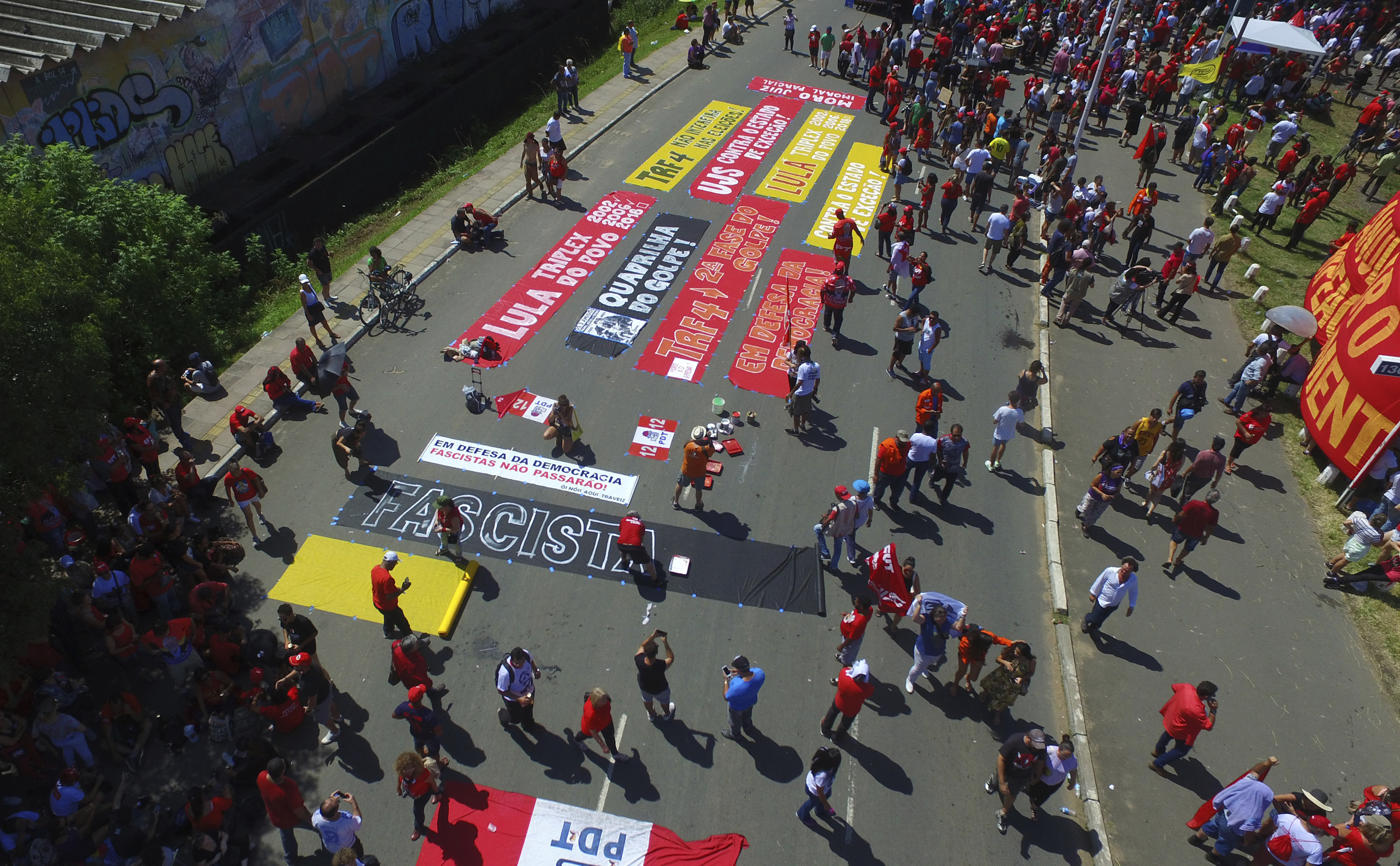 Supporters of ex-President Luiz Inacio Lula da Silva gather near the Federal Regional Court, where a three-member court is considering whether to uphold or throw out a corruption conviction against da Silva, in Porto Alegre, Brazil, Wednesday, Jan. 24, 2018. The decision could impact whether the former leader can run for president. The 72-year-old leads preference polls for October’s race. (AP Photo/Wesley Santos)