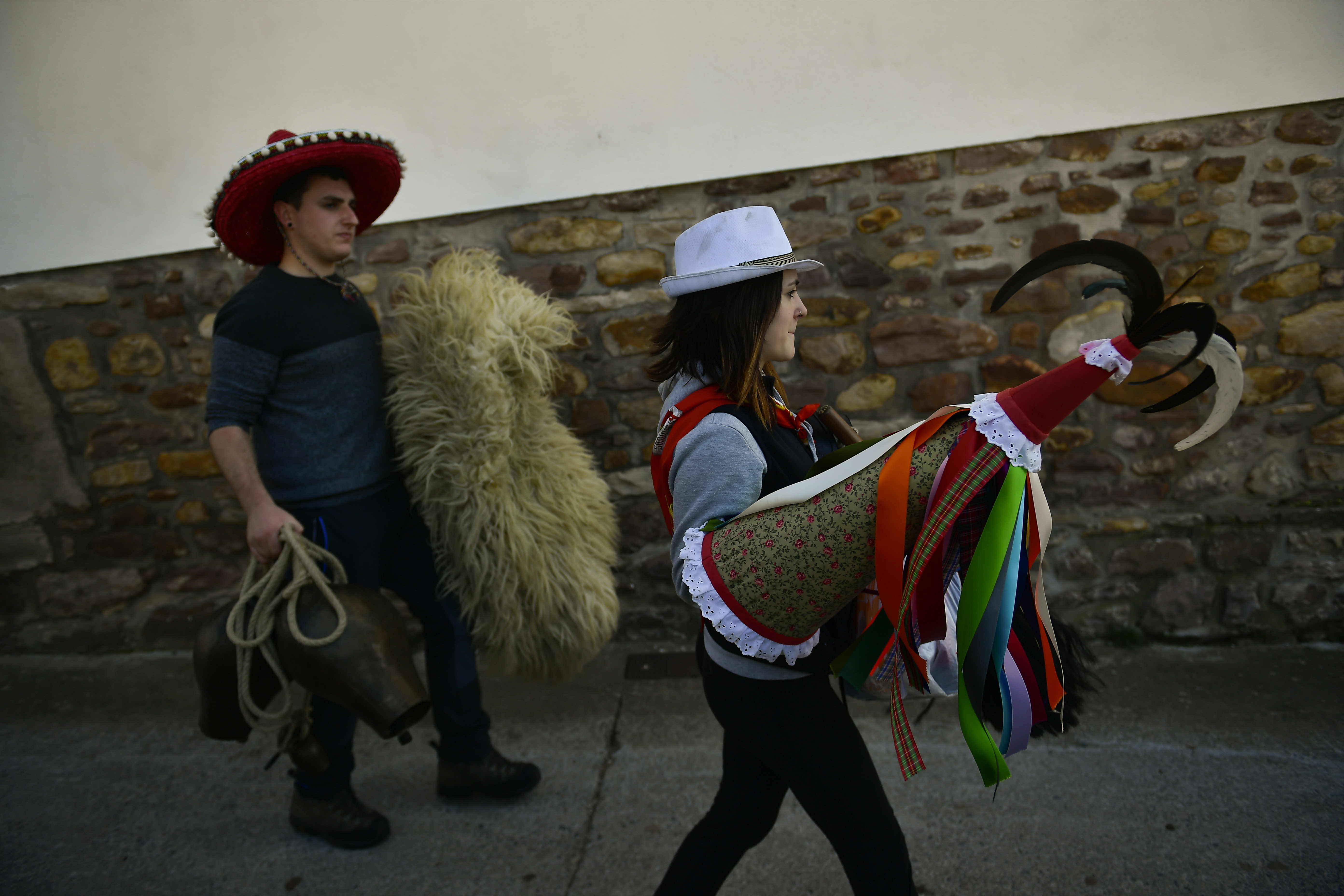A Joaldunaks called Zanpantzar, prepares to takes part in the Carnival between the Pyrenees villages of Ituren and Zubieta, northern Spain, Monday, Jan. 29, 2018. In one of the most ancient carnivals in Europe, dating from before the Roman empire, companies of Joaldunak (cowbells) made up of residents of two towns, Ituren and Zubieta, parade the streets costumed in sandals, lace petticoats, sheepskins around the waist and shoulders, coloured neckerchiefs, conical caps with ribbons and a hyssop of horsehair in their right hands and cowbells hung across their lower back. (AP Photo/Alvaro Barrientos)