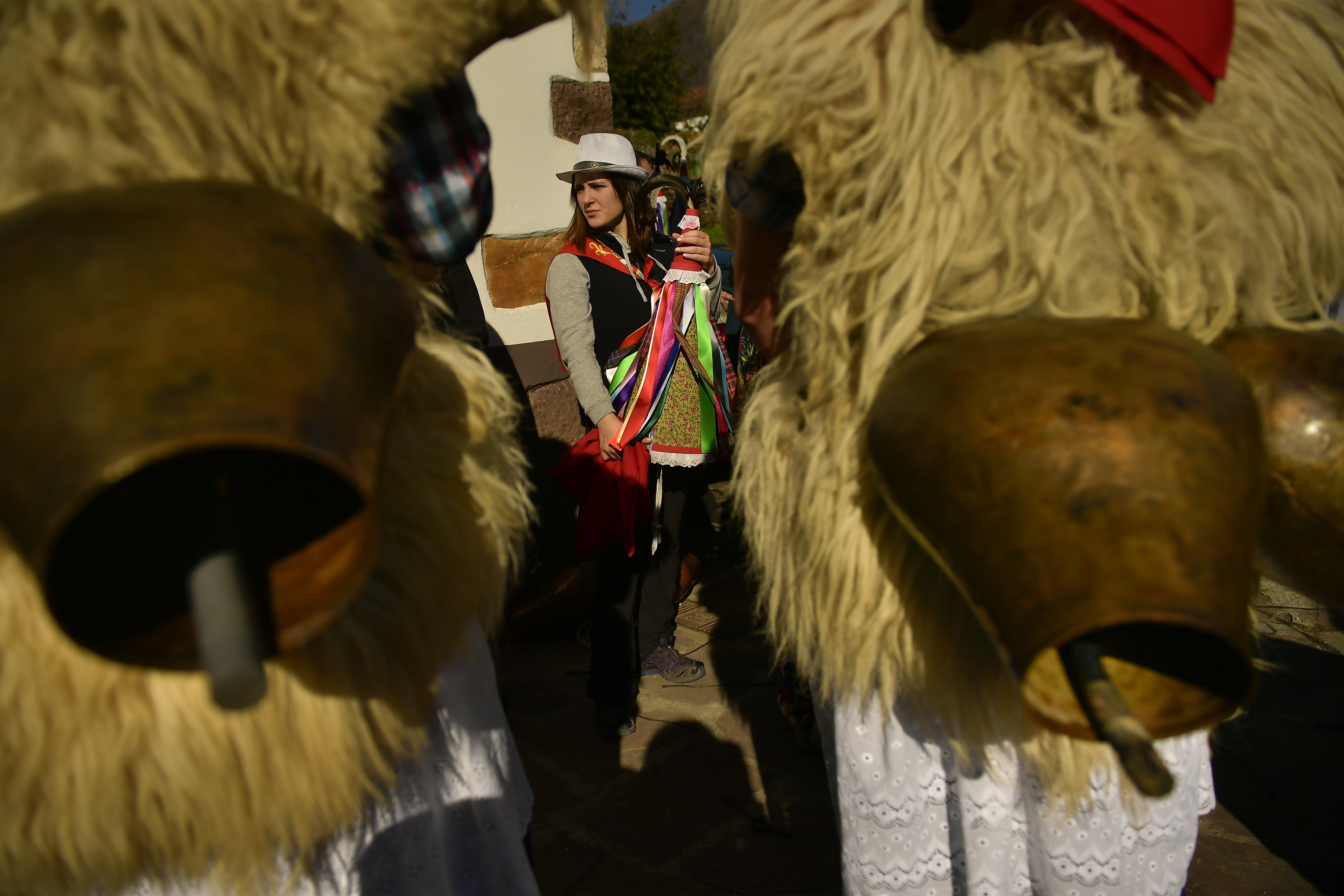 A Joaldunak called Zanpantzar, center, prepares to takes part in the Carnival between the Pyrenees villages of Ituren and Zubieta, northern Spain, Monday, Jan. 29, 2018. In one of the most ancient carnivals in Europe, dating from before the Roman empire, companies of Joaldunak (cowbells) made up of residents of two towns, Ituren and Zubieta, parade the streets costumed in sandals, lace petticoats, sheepskins around the waist and shoulders, coloured neckerchiefs, conical caps with ribbons and a hyssop of horsehair in their right hands and cowbells hung across their lower back. (AP Photo/Alvaro Barrientos)