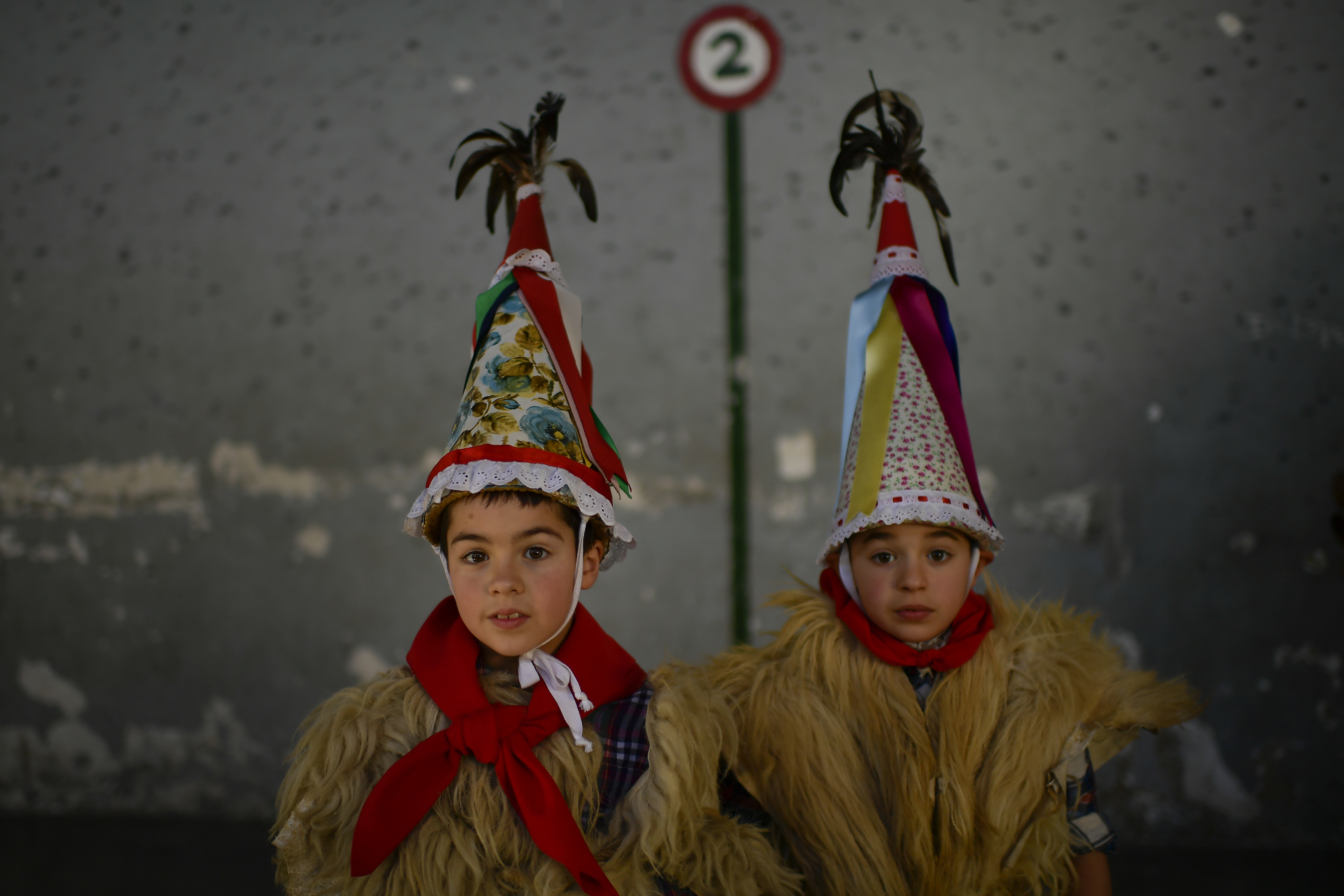EDS NOTE : SPANISH LAW REQUIRES THAT THE FACES OF MINORS ARE MASKED IN PUBLICATIONS WITHIN SPAIN. Two young Joaldunaks called Zanpantzar, take part in the Carnival between the Pyrenees villages of Ituren and Zubieta, northern Spain, Monday, Jan. 30, 2017. In one of the most ancient carnivals in Europe, dating from before the Roman empire, companies of Joaldunak (cowbells) made up of residents of two towns, Ituren and Zubieta, parade the streets costumed in sandals, lace petticoats, sheepskins around the waist and shoulders, coloured neckerchiefs, conical caps with ribbons and a hyssop of horsehair in their right hands and cowbells hung across their lower back. (AP Photo/Alvaro Barrientos)