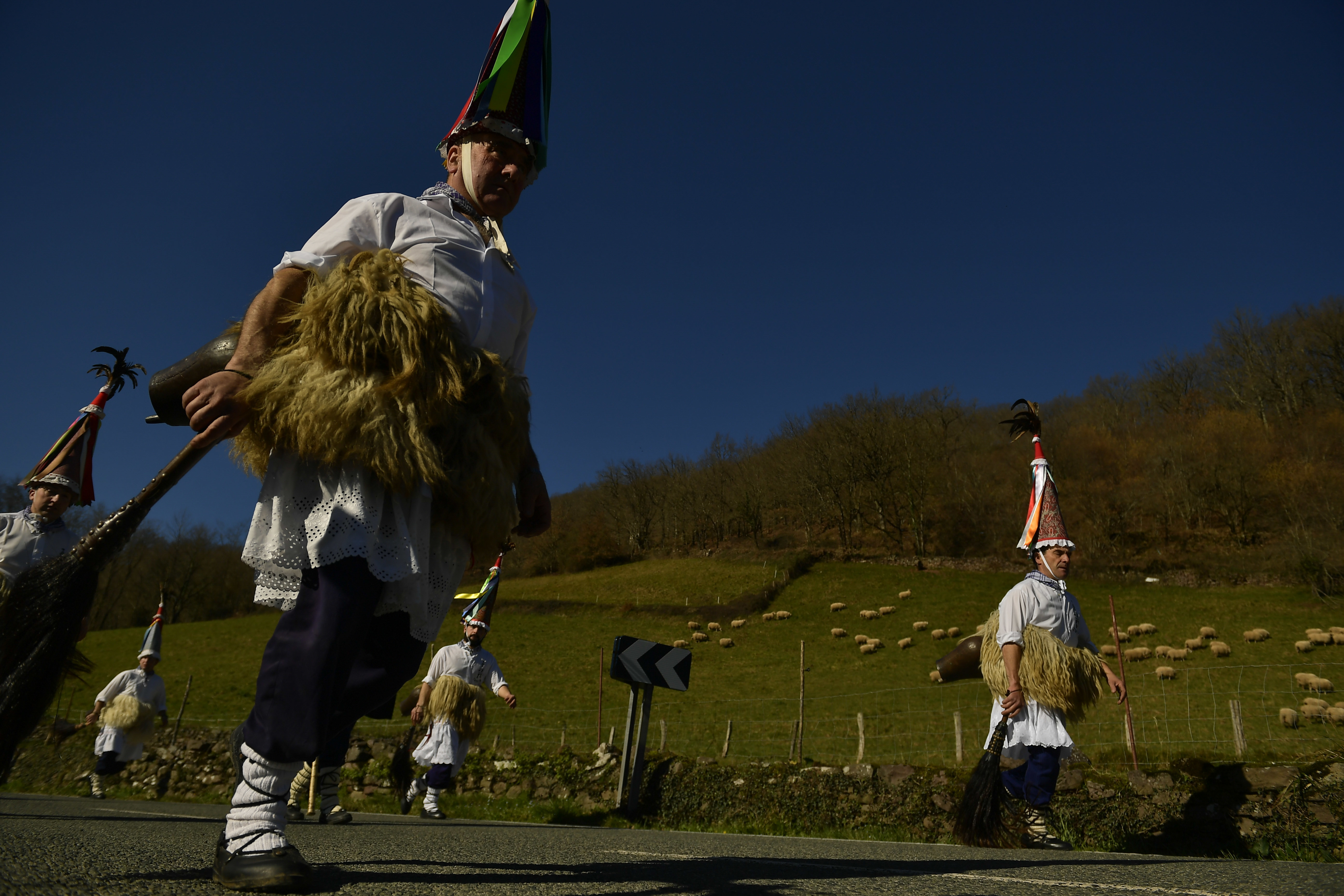 A group of Joaldunaks called Zanpantzar, take part in the Carnival between the Pyrenees villages of Ituren and Zubieta, northern Spain, Monday, Jan. 29, 2018. In one of the most ancient carnivals in Europe, dating from before the Roman empire, companies of Joaldunak (cowbells) made up of residents of two towns, Ituren and Zubieta, parade the streets costumed in sandals, lace petticoats, sheepskins around the waist and shoulders, coloured neckerchiefs, conical caps with ribbons and a hyssop of horsehair in their right hands and cowbells hung across their lower back. (AP Photo/Alvaro Barrientos)