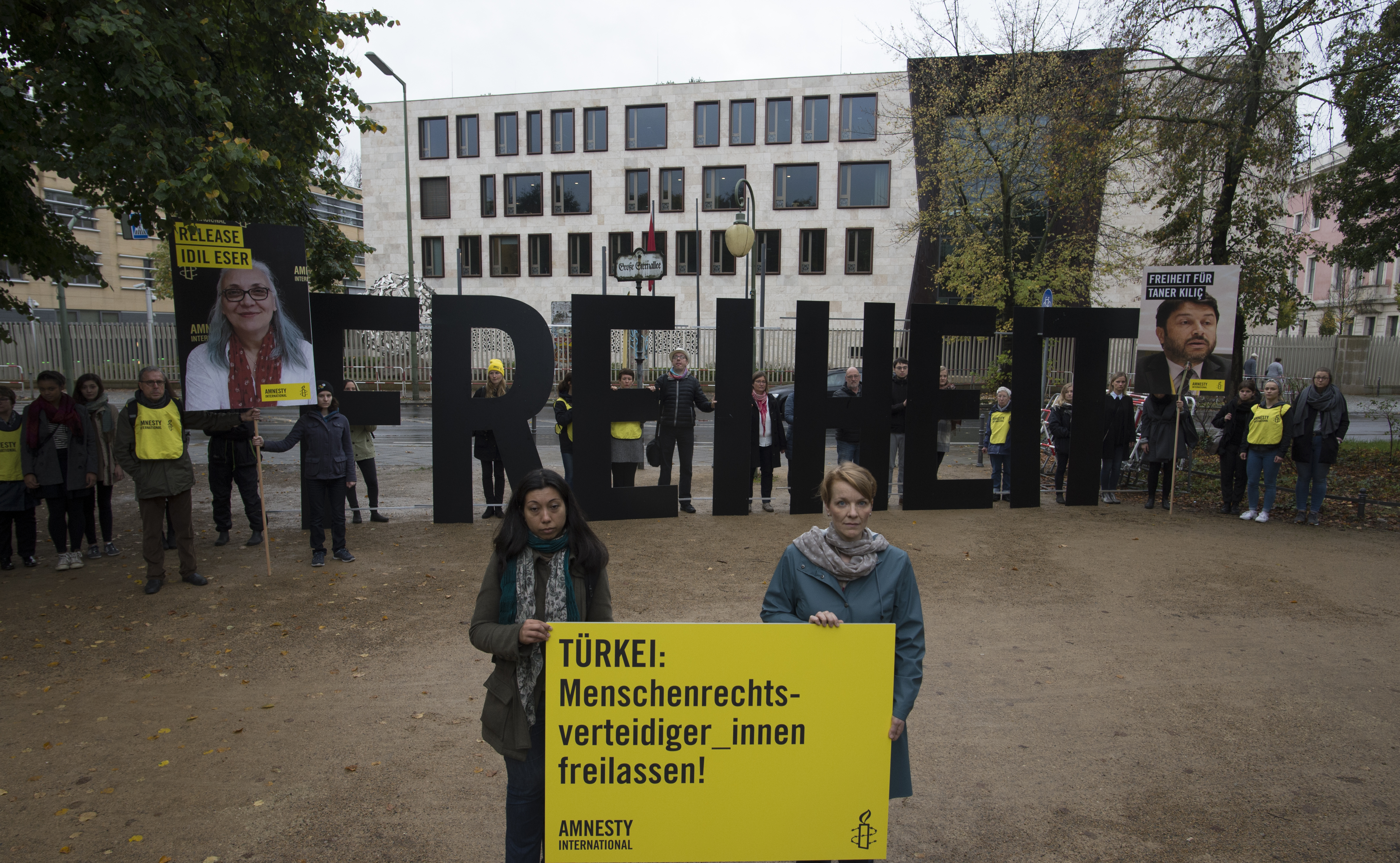 Activits of Amnesty International hold up large letters spelling 