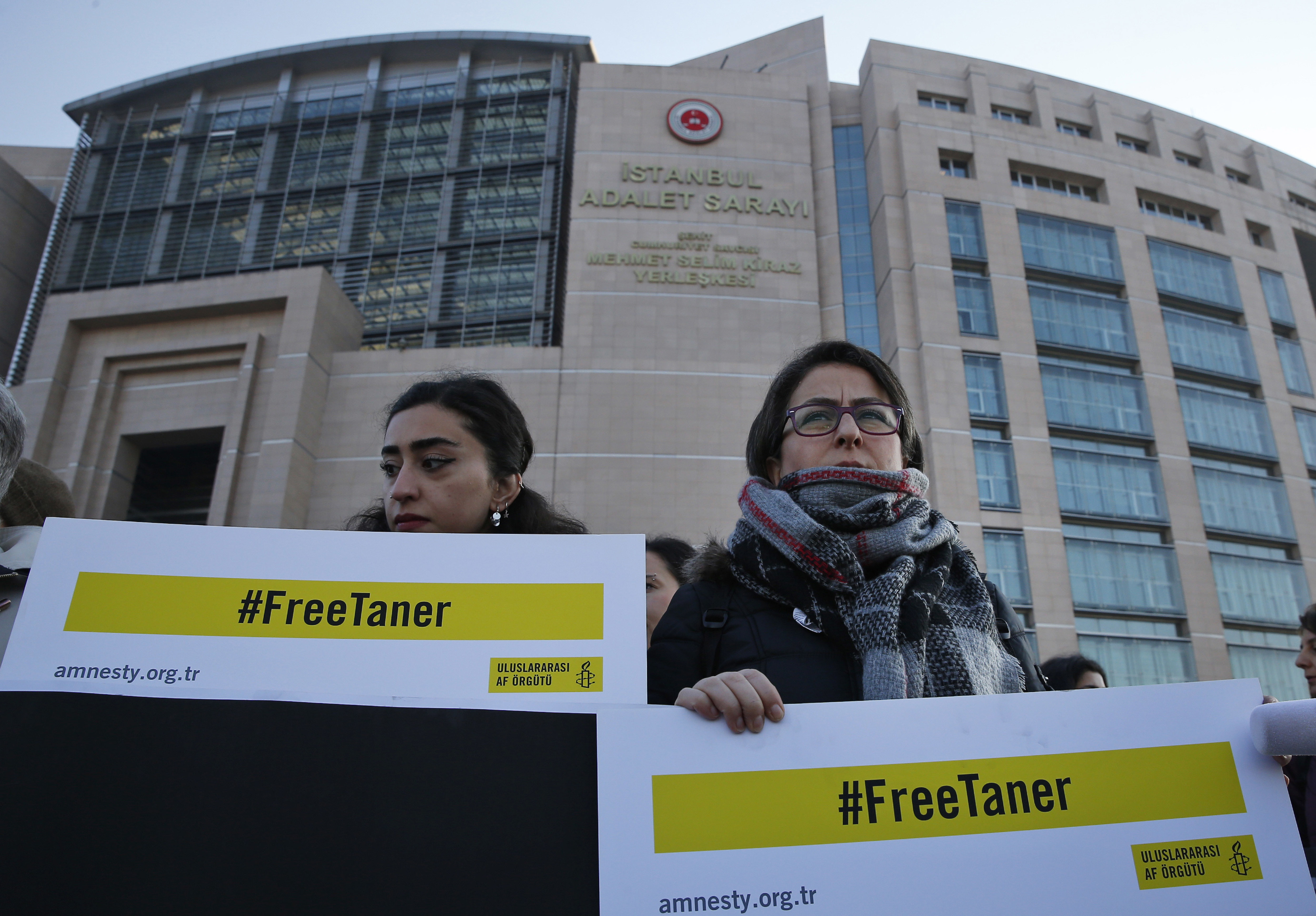 Human rights activists stage a protest outside a court in Istanbul, Wednesday, Jan. 31, 2018, where the trial of eleven human rights activists accused of belonging to and aiding terror groups is ongoing. The protesters demand the release of Amnesty's Turkey chairman Taner Kilic, who was imprisoned separately in June 2017, and goes on trial in the city of Izmir for alleged links to U.S.-based cleric Fethullah Gulen, blamed by the government for last year's coup attempt. (AP Photo/Lefteris Pitarakis)