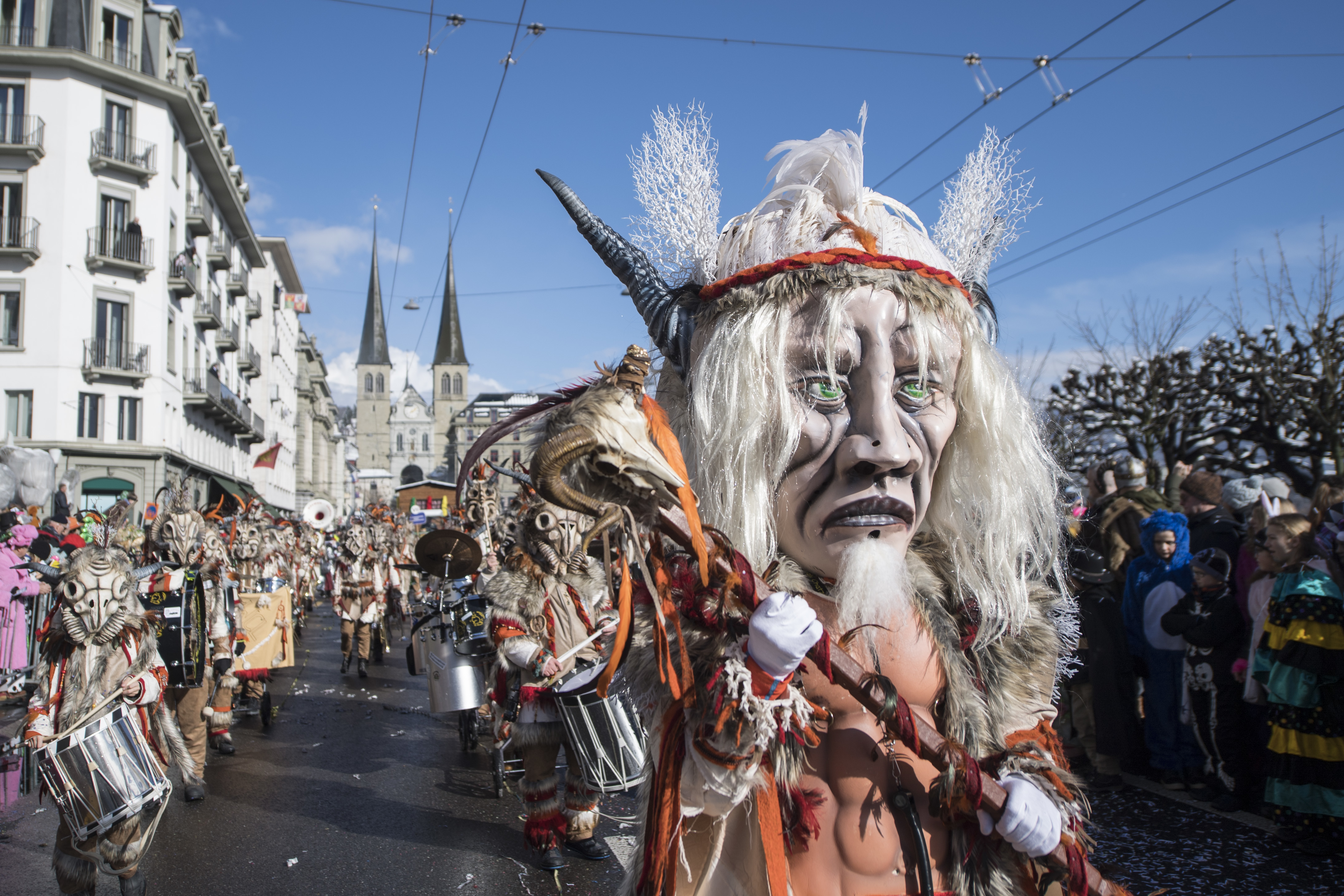 Masked revelers parade through the streets during the the carnival season in Lucerne, Switzerland, Monday, Feb. 12, 2018. (Urs Flueeler/Keystone via AP)