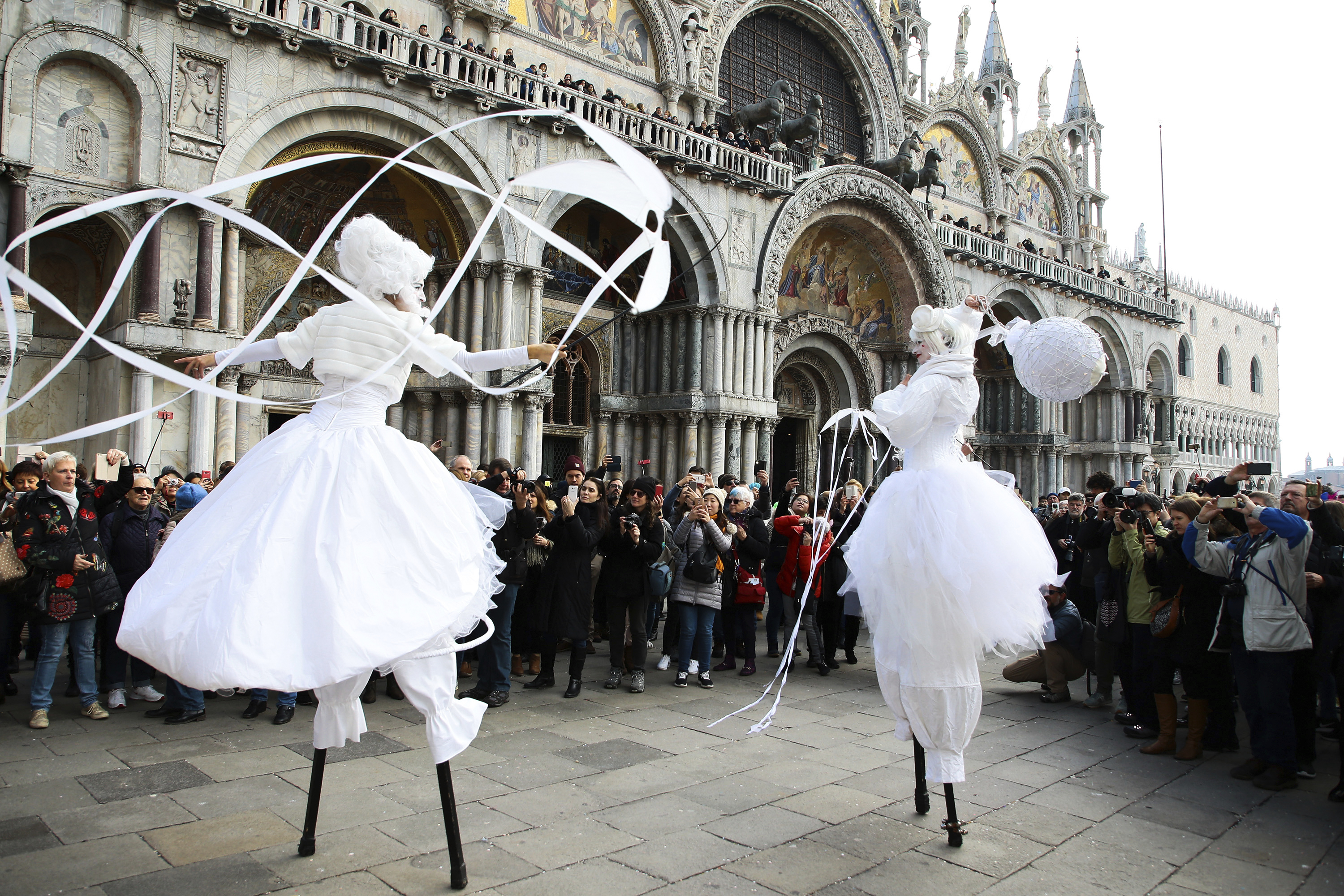 People wearing costumes attend the traditional events of Carnival 'Cutting off the Bull's head' and 'Dance of the Masks' on February 8, 2018 in Venice, Italy. The 'Cutting off the Bull's head' is an ancient tradition that commemorates the victory of the Doge Vitale Michiel II over the rebel Ulrich, Patriarch of Aquileia and 12 feudal lords in 1162. (Photo by Matteo Chinellato/NurPhoto/Sipa USA)(Sipa via AP Images)