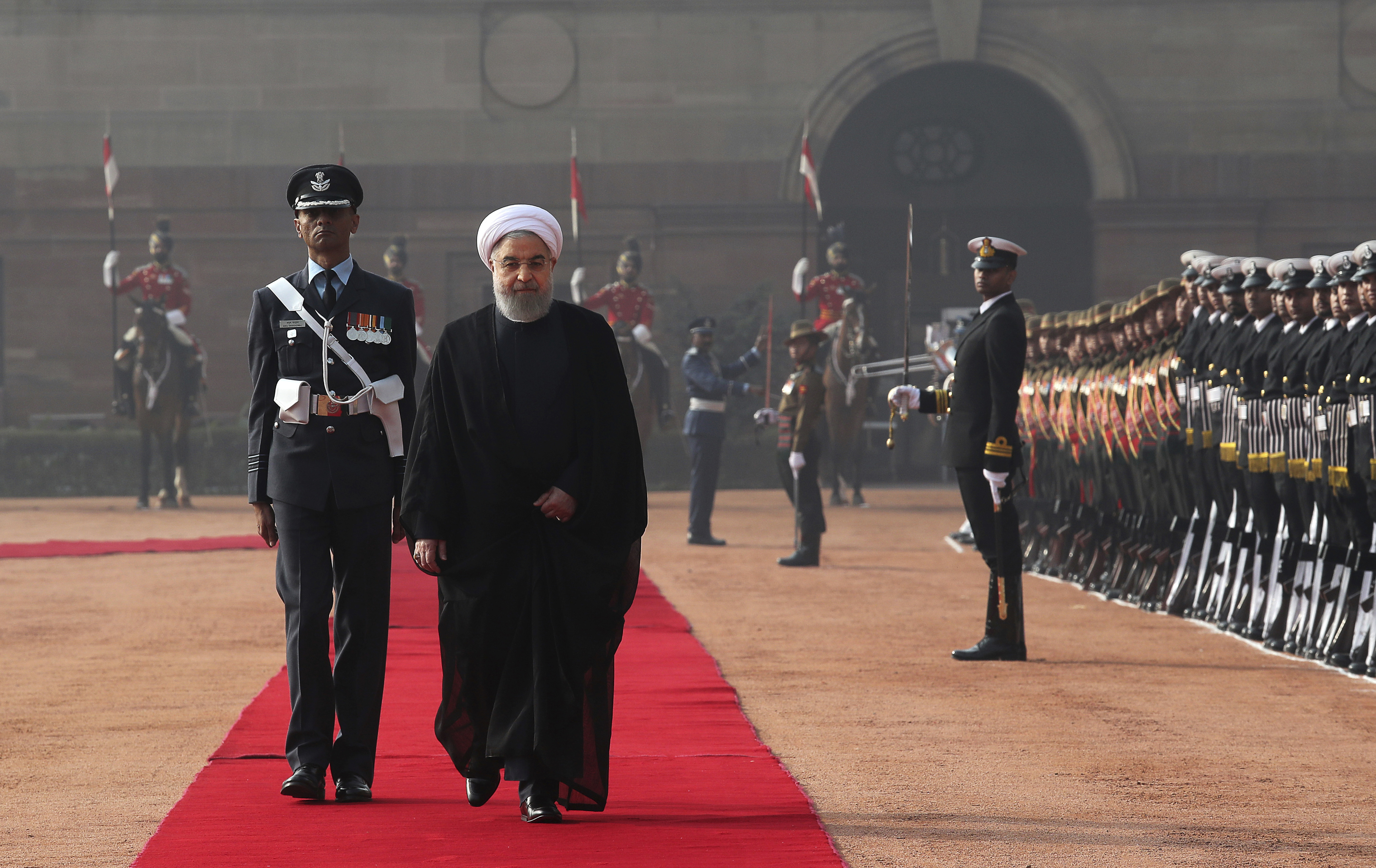 Iranian President Hassan Rouhani inspects a joint military guard of honor during his ceremonial reception at the Indian presidential palace, in New Delhi, India, Saturday, Feb. 17, 2018. Rouhani, who is on three days state visit to India has strongly criticized the Trump administration's recognition of Jerusalem as Israel's capital and urged Muslims to support the Palestinian cause. (AP Photo/Manish Swarup)