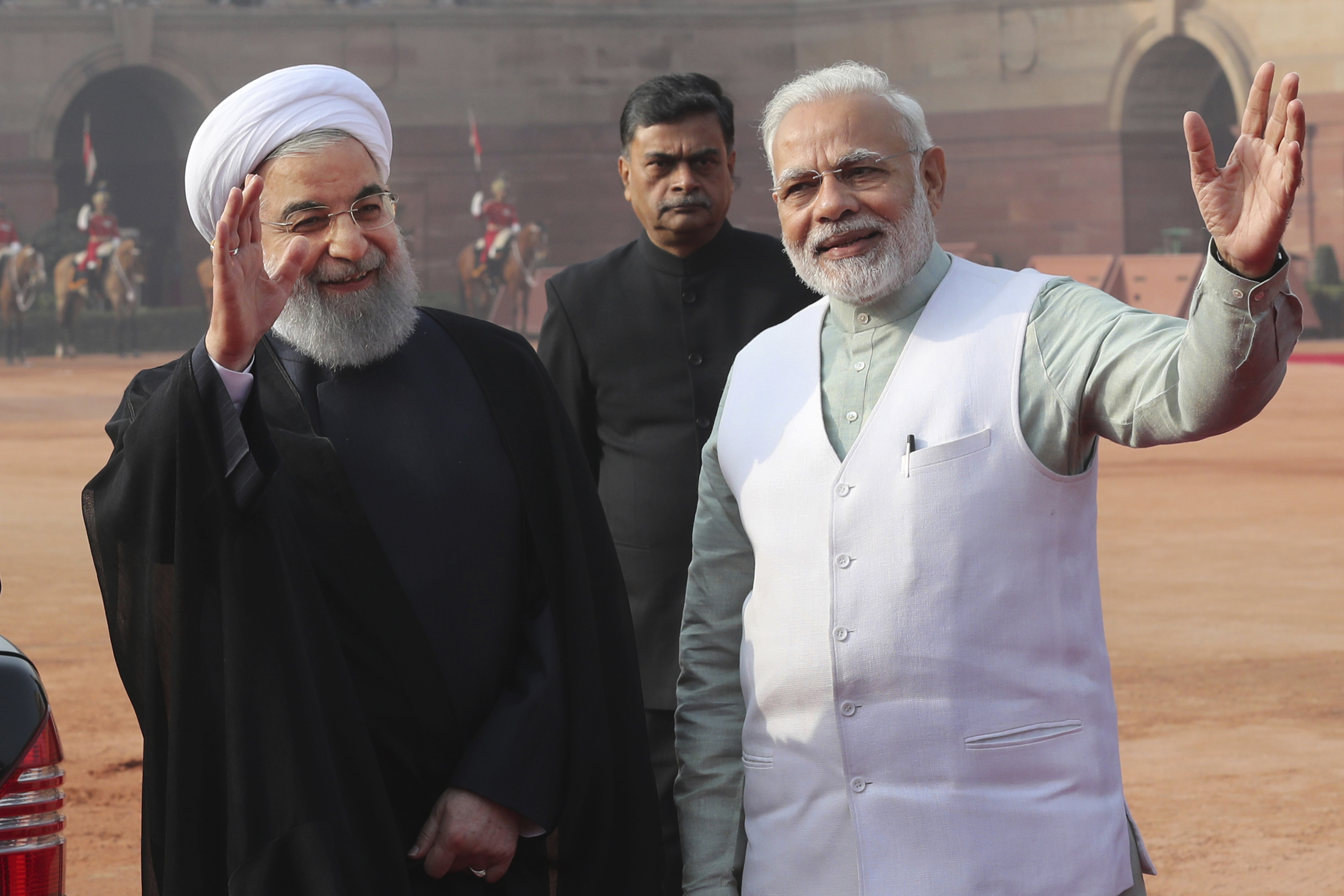 Indian Prime Minister Narendra Modi, right, and Iranian President Hassan Rouhani, left, wave to media as later's leaves after a ceremonial reception from the Indian presidential palace, in New Delhi, India, Saturday, Feb. 17, 2018. Rouhani, who is on three days state visit to India has strongly criticized the Trump administration's recognition of Jerusalem as Israel's capital and urged Muslims to support the Palestinian cause. (AP Photo/Manish Swarup)