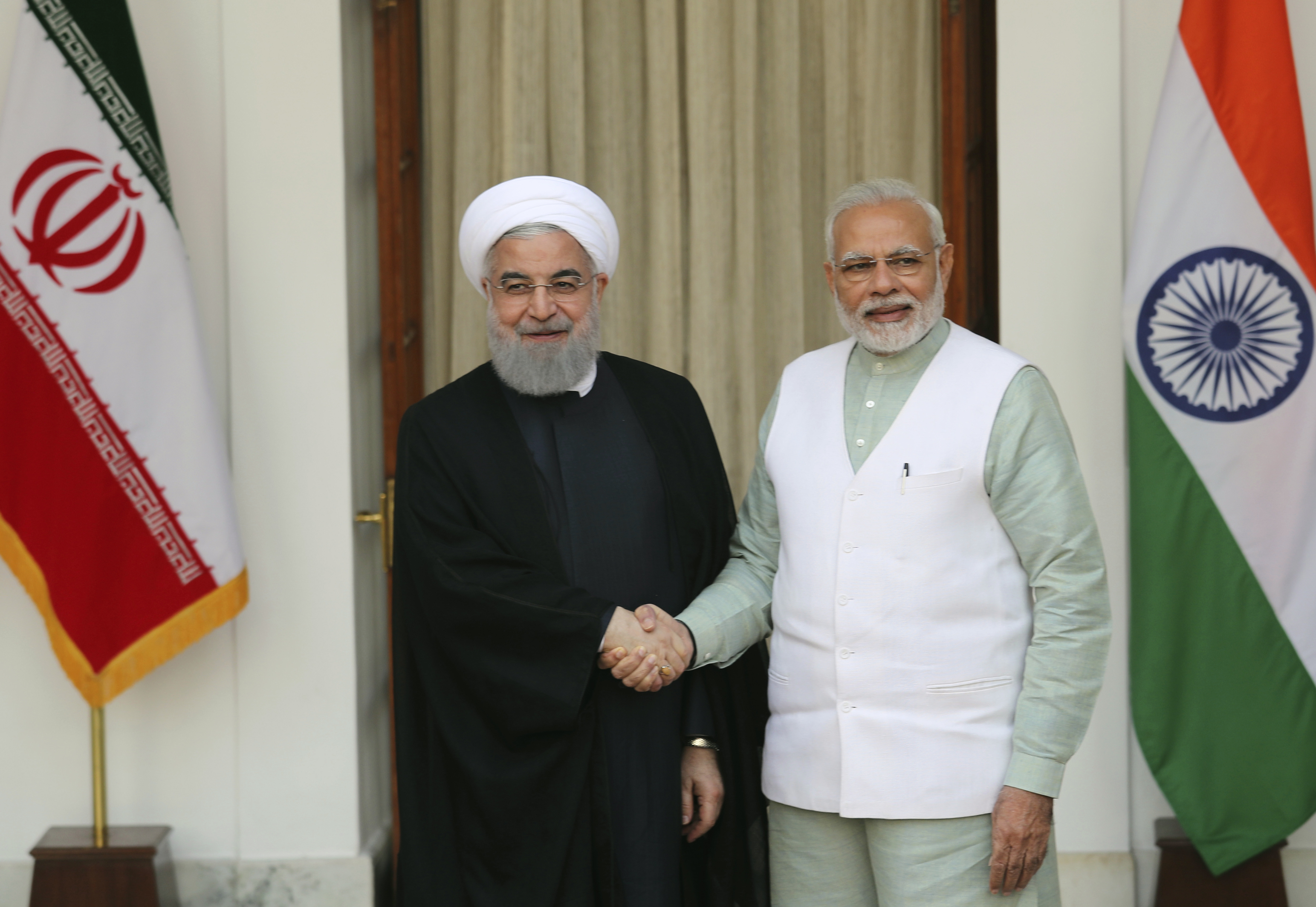 Indian Prime Minister Narendra Modi, right, shakes hand with Iranian President Hassan Rouhani, before their delegation level meeting in New Delhi, India, Saturday, Feb. 17, 2018. Rouhani, who is on three days state visit to India has strongly criticized the Trump administration's recognition of Jerusalem as Israel's capital and urged Muslims to support the Palestinian cause. (AP Photo/Manish Swarup)