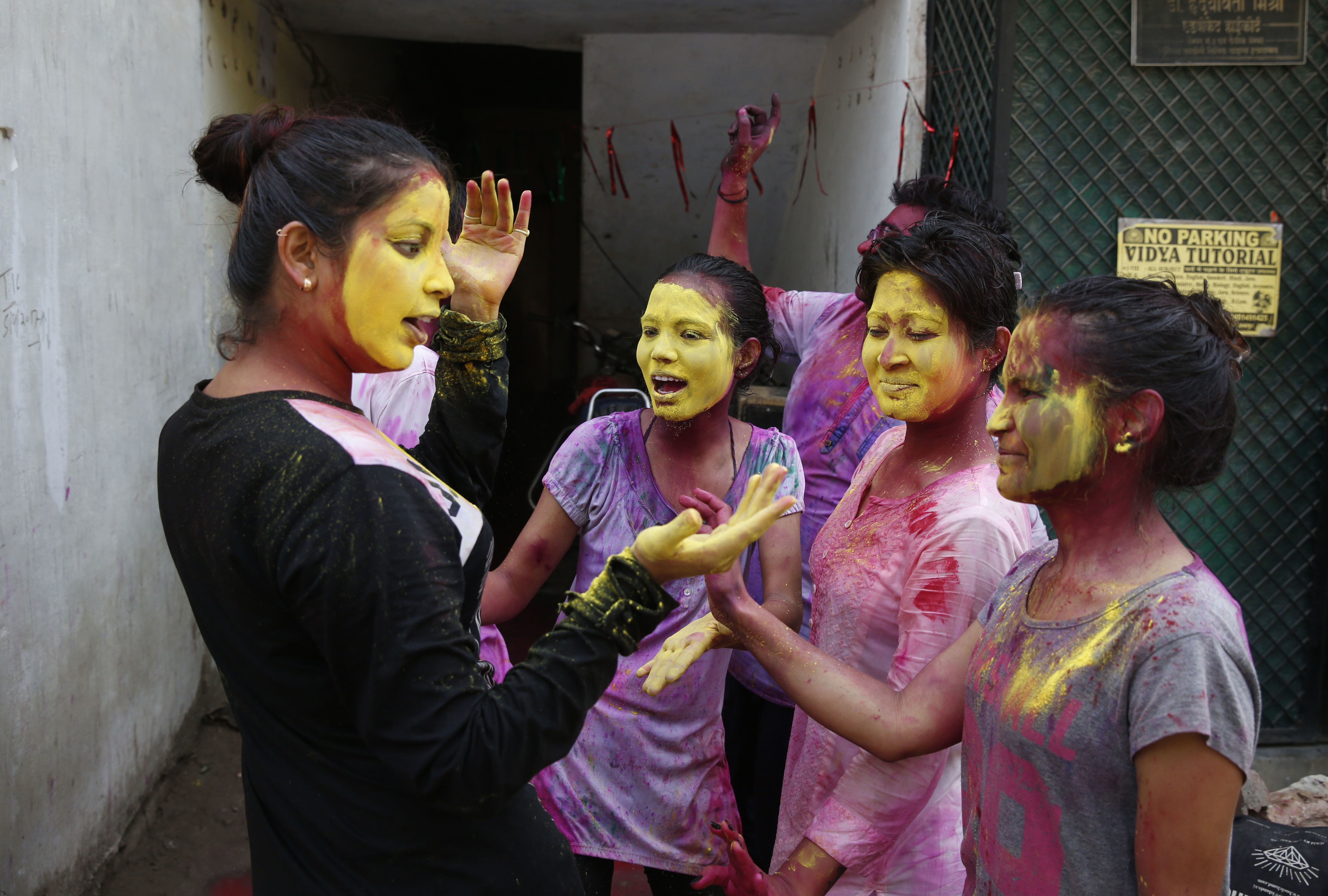 Indian revelers, faces smeared with colored powder, celebrate Holi, the Hindu festival of colors in Allahabad, India, Friday, March 2, 2018. The festival, a celebration of warm weather, good harvests and the defeat of evil, brings out millions of people, from toddlers to the elderly, to throw powder at one another and play with water balloons and squirt guns. (AP Photo/Rajesh Kumar Singh)