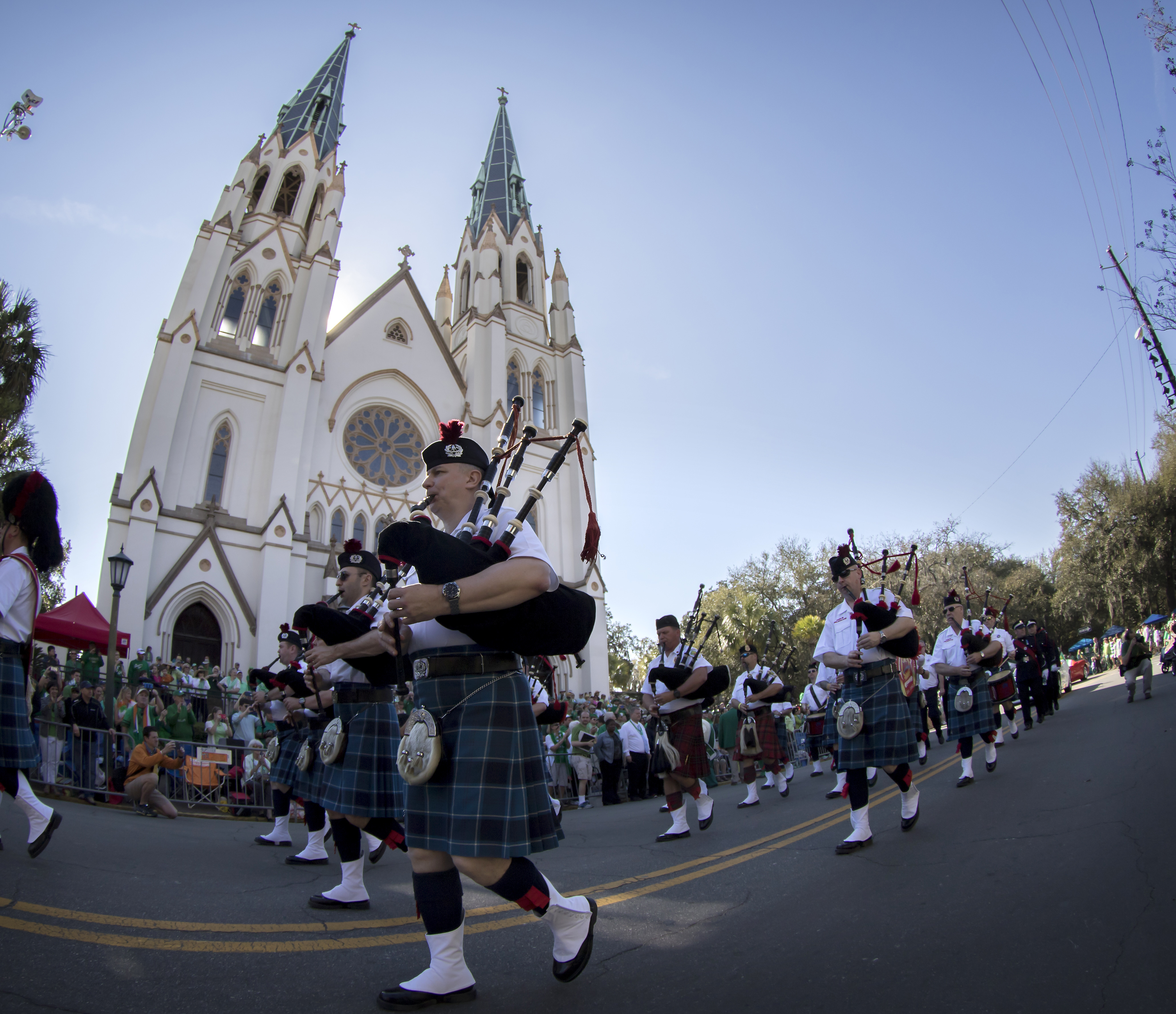 FILE- In this March 17, 2015 file photo members of the Dublin Fire Brigade Pipe Band perform while marching past The Cathedral of St. John The Baptist during the St. Patrick's Day parade in Savannah, Ga. Vice President Mike Pence is planning to attend Savannah's St. Patrick's Day parade. (AP Photo/Stephen B. Morton, File)