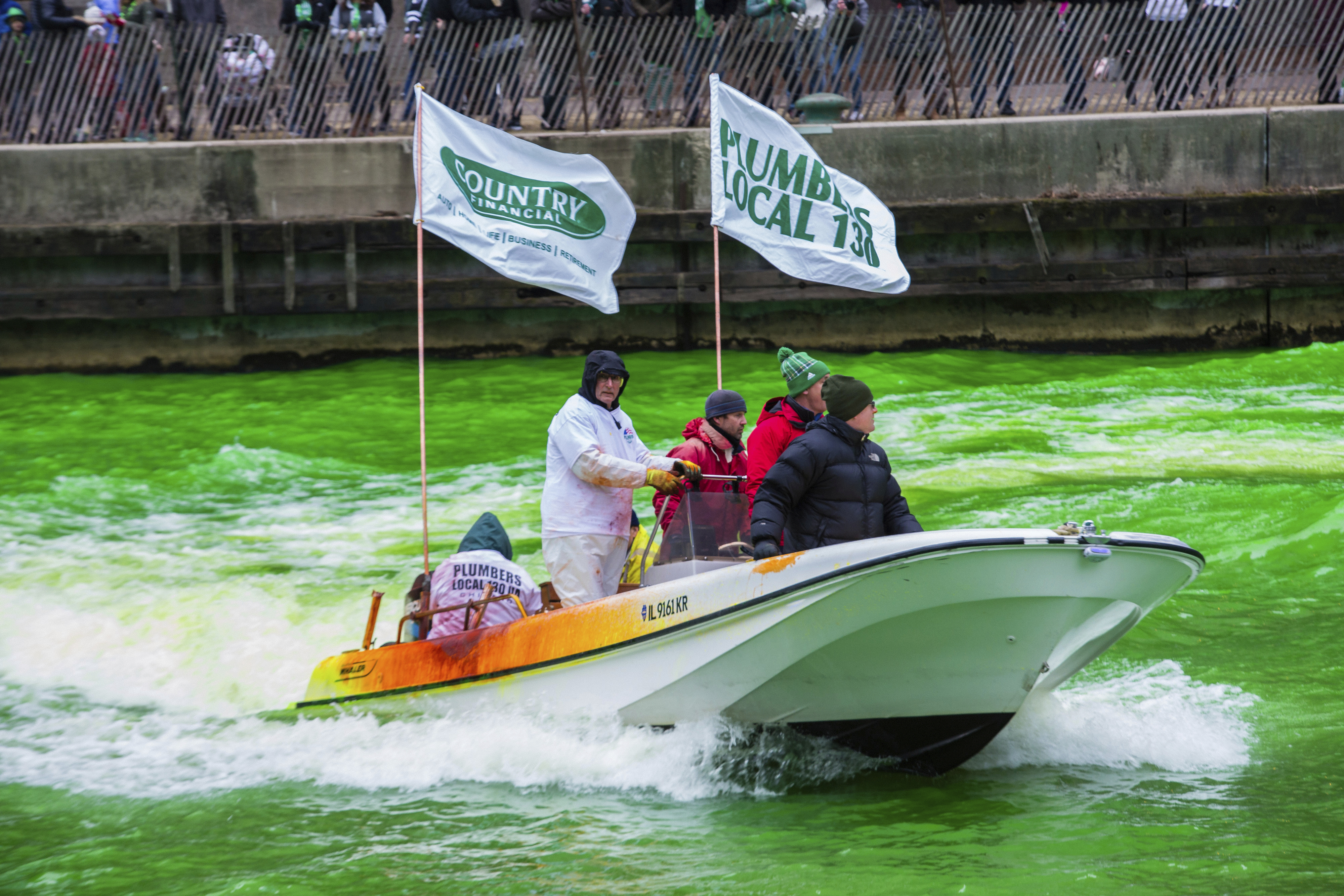 The Plumber's Local Union 130 dyes the Chicago River green to celebrate St. Patrick's Day, Saturday, March 17th, 2018.   Thousands of people lined the riverfront downtown Chicago  to see the dyeing, a tradition for the holiday that dates to 1962.   (James Foster/Chicago Sun-Times via AP)
