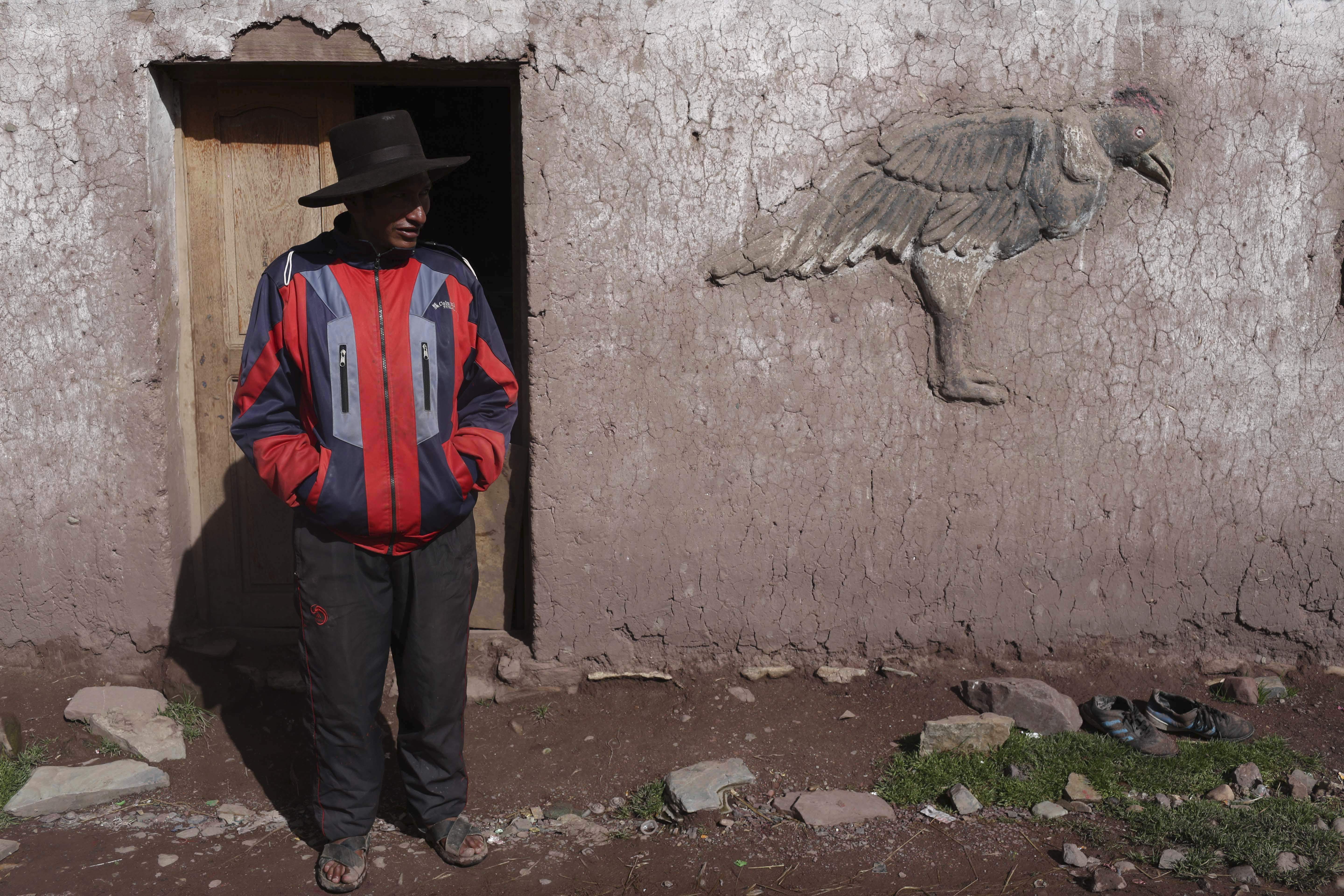 In this March 2, 2018 photo, Miguel Rocco stands in front of his home in Pitumarca, Peru. The local indigenous community has struggled with high rates of alcoholism, malnutrition and falling prices of wool from their prized alpaca. (AP Photo/Martin Mejia)