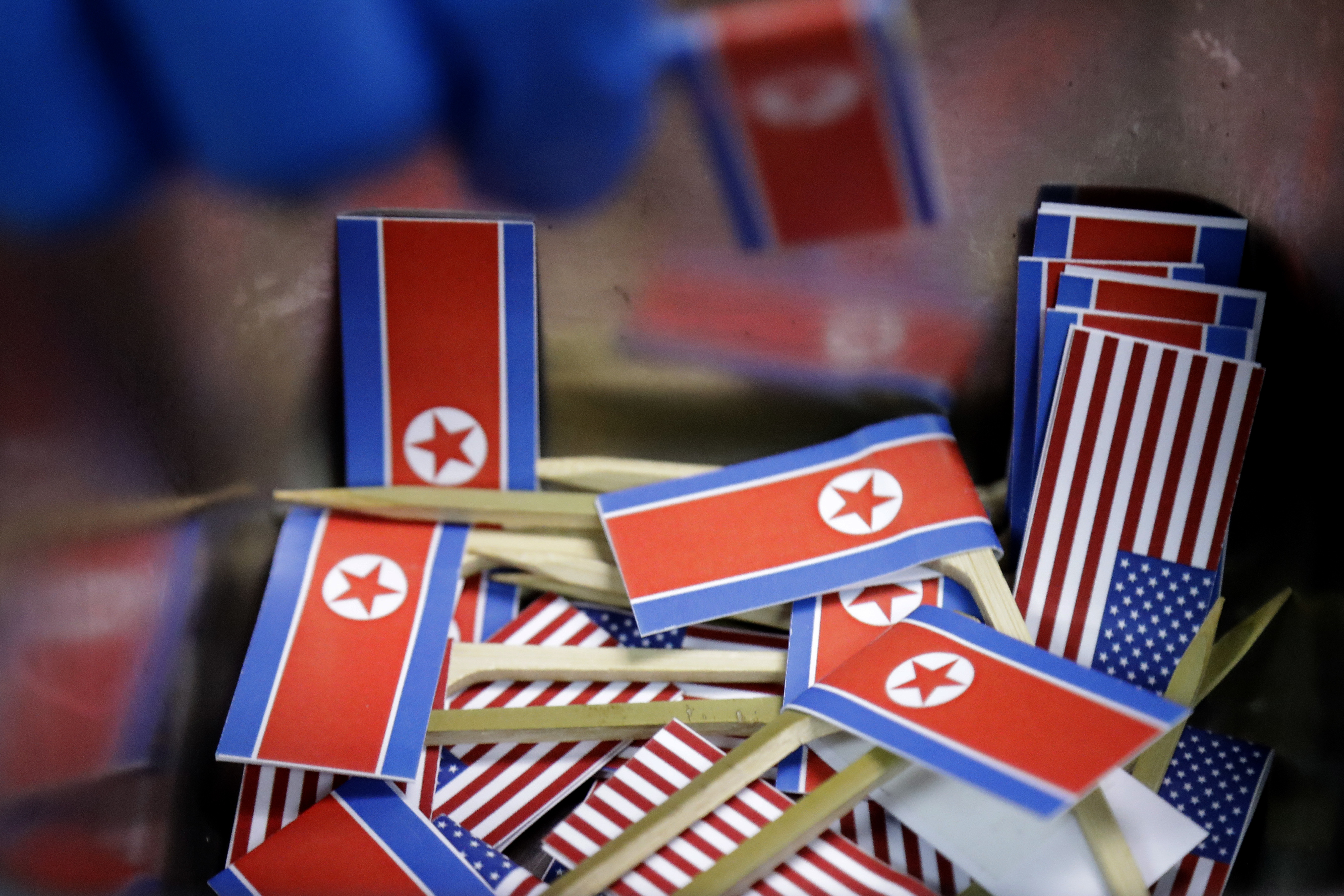 In this June 7, 2018, photo, miniature American and North Korean flags are piled together and used to decorate the 