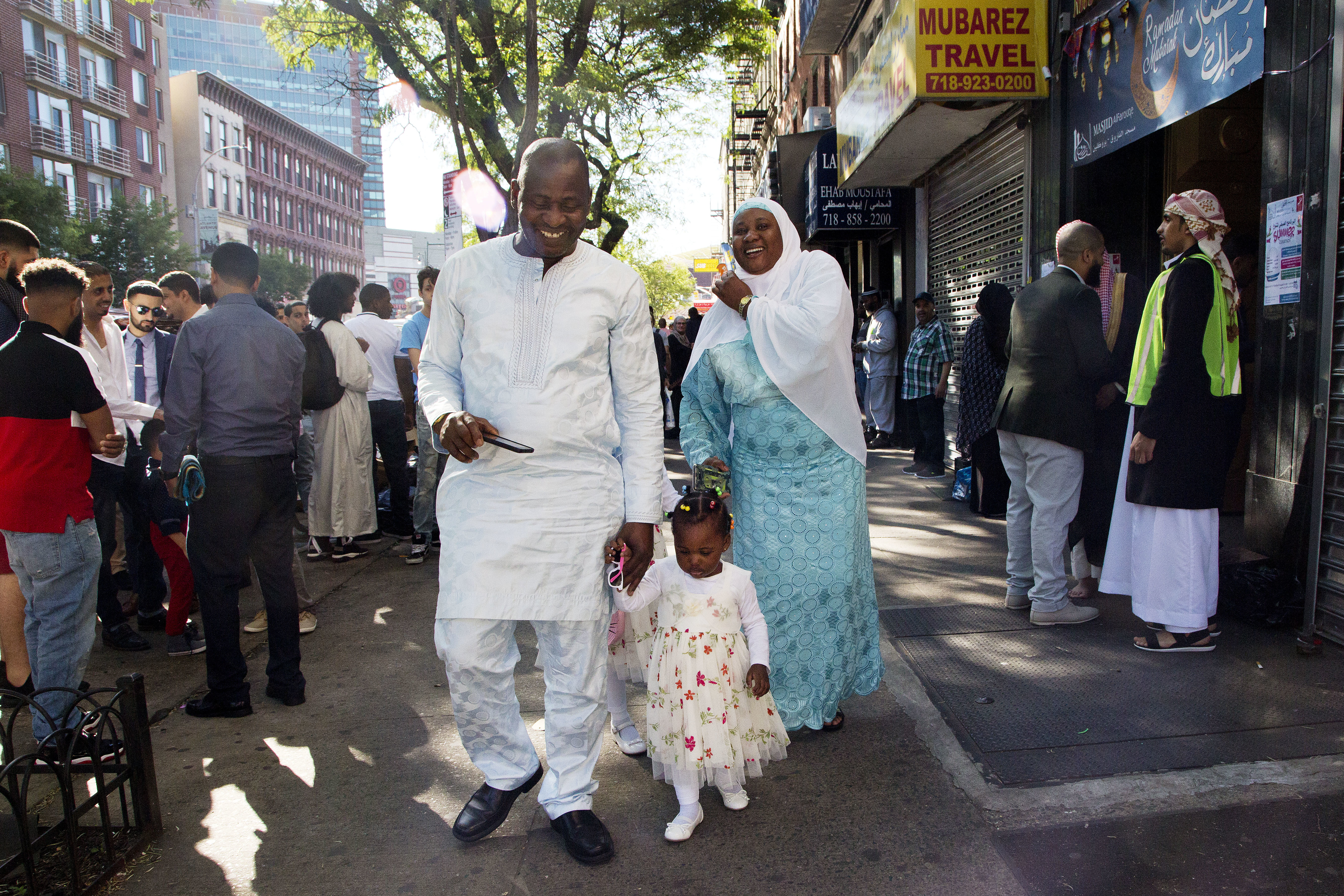A family leaves Masjid Al-Farooq following a prayer service for the Muslim holiday of Eid al-Fitr, Friday, June 15, 2018, in the Brooklyn borough of New York. They join hundreds of millions of Muslims around the world in marking the holiday that caps the fasting month of Ramadan. (AP Photo/Mark Lennihan)